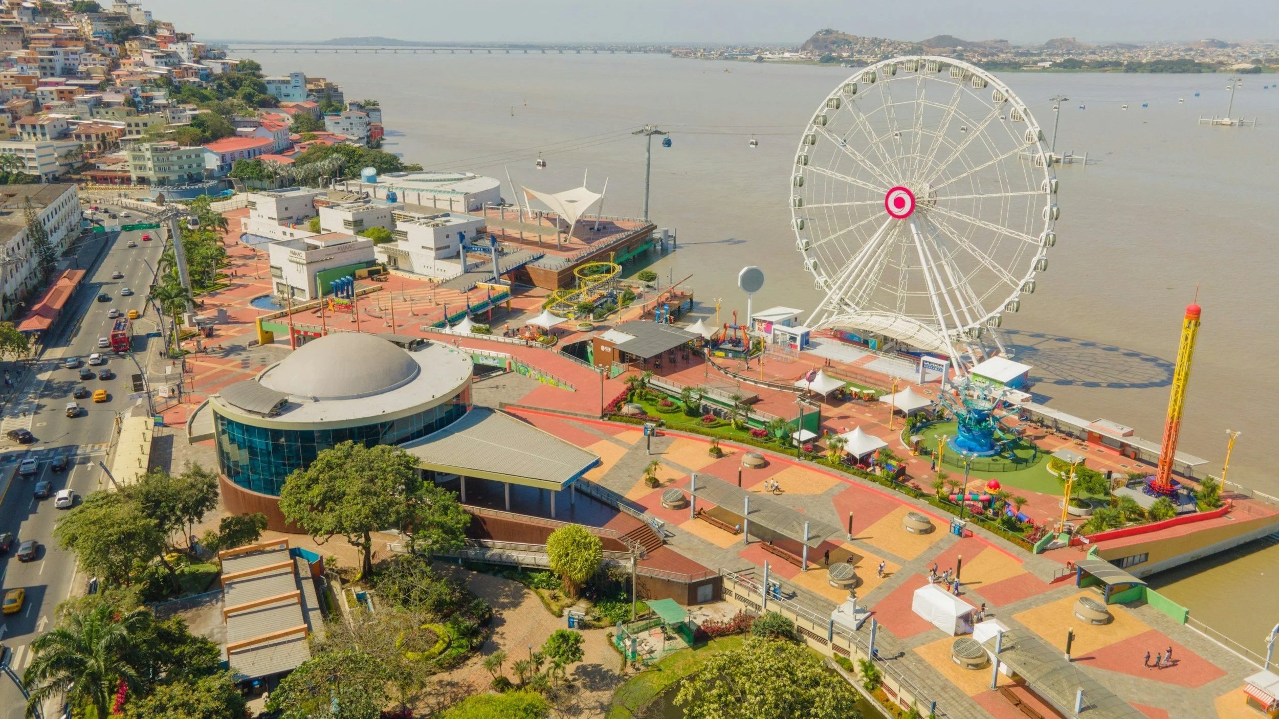 Aerial view of Malecón 2000 in Guayaquil, Ecuador, featuring the riverfront promenade and Ferris wheel along the Guayas River, captured during a luxury Ecuador itinerary.