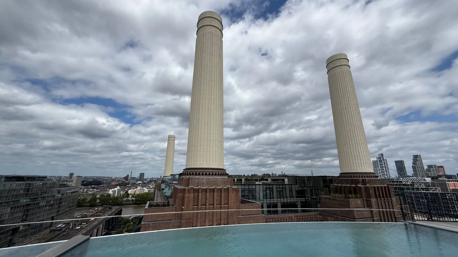 Rooftop infinity pool at art’otel London Battersea Power Station overlooking the iconic Battersea chimneys and London skyline