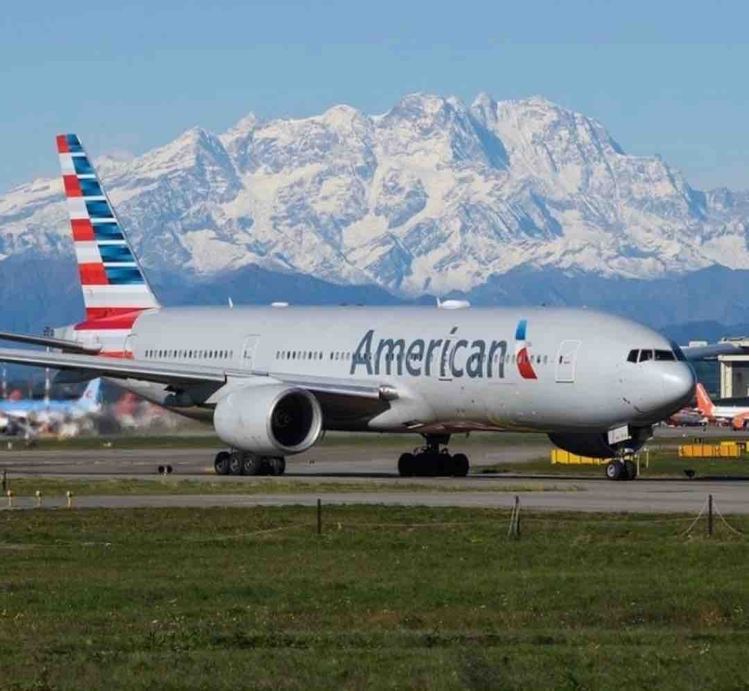 American Airlines plane with snowy mountain backdrop
