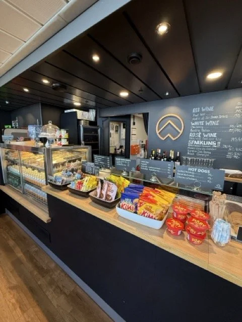 Onboard café serving Prosecco, snacks and locally made treats during the cruise.