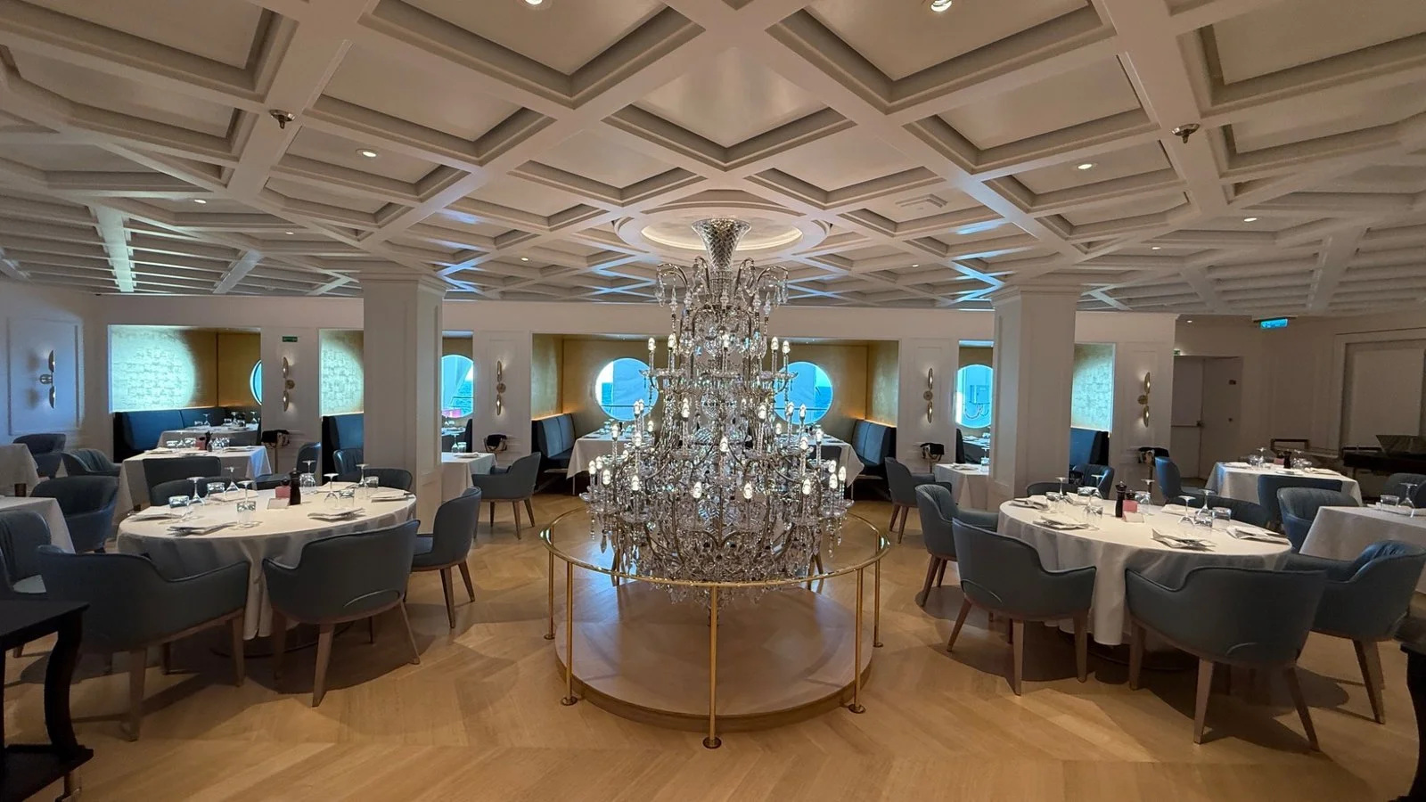 Restaurant on Norwegian Luna with chandelier centrepiece and refined dining setting