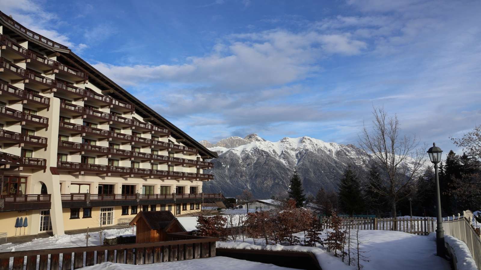 Exterior view of Interalpen-Hotel Tyrol set against the Alps in winter