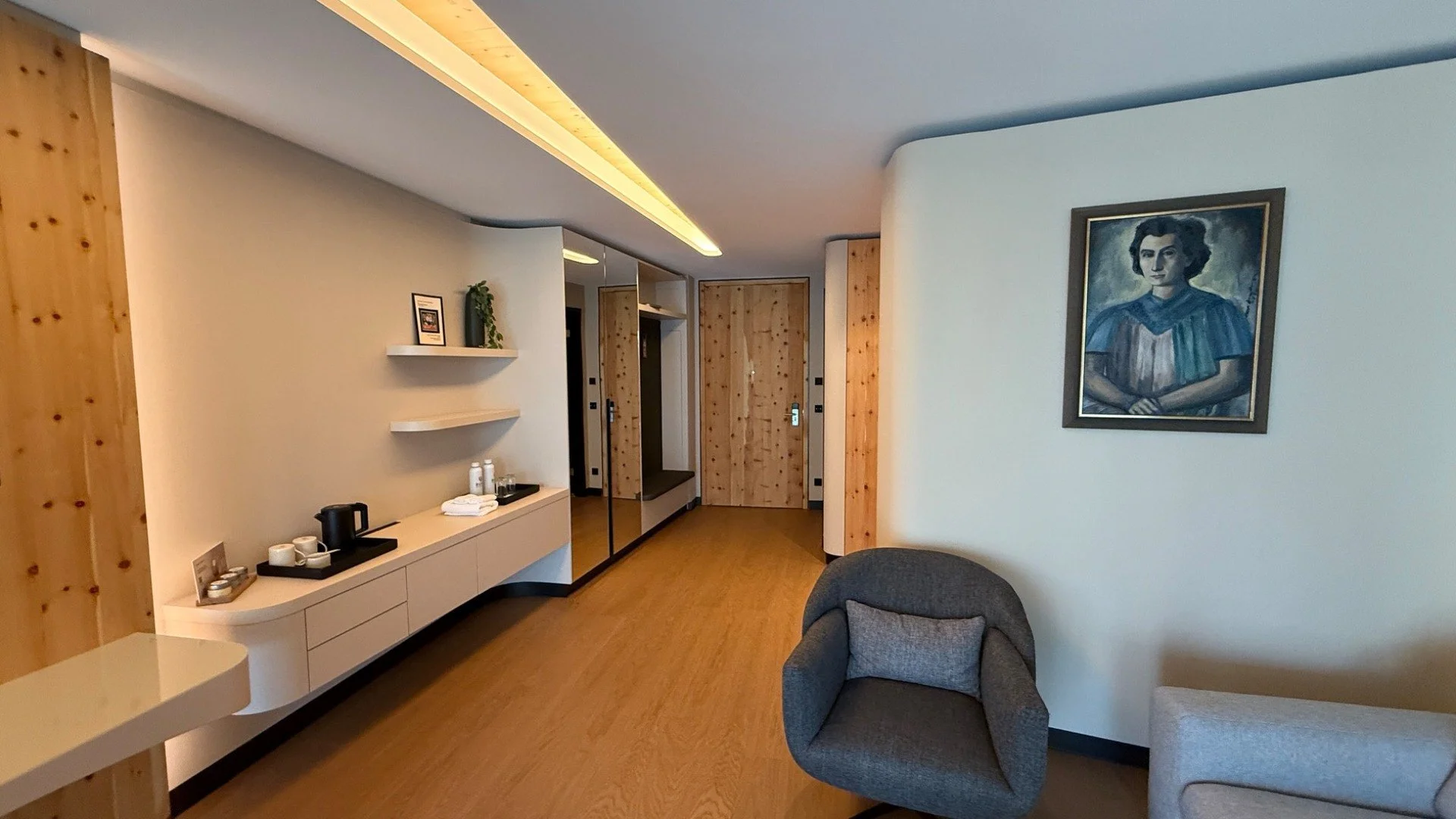 Contemporary guest room at Buff Medical Resort Germany, with natural wood finishes, curved furniture and minimalist modern design.