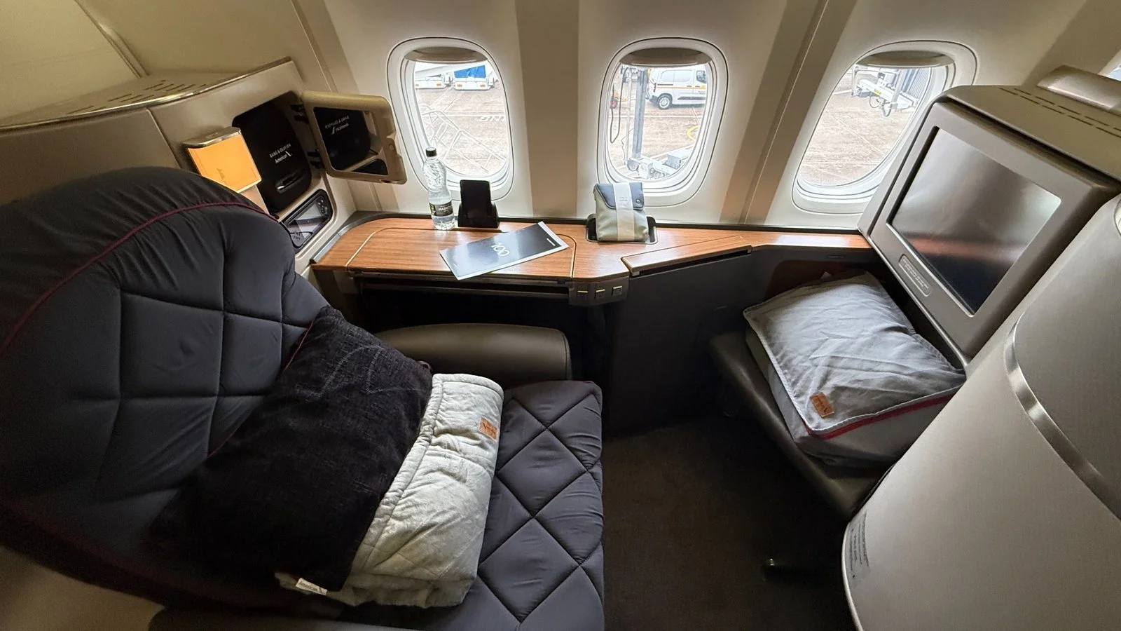 American Airlines first class seat with window view at Heathrow
