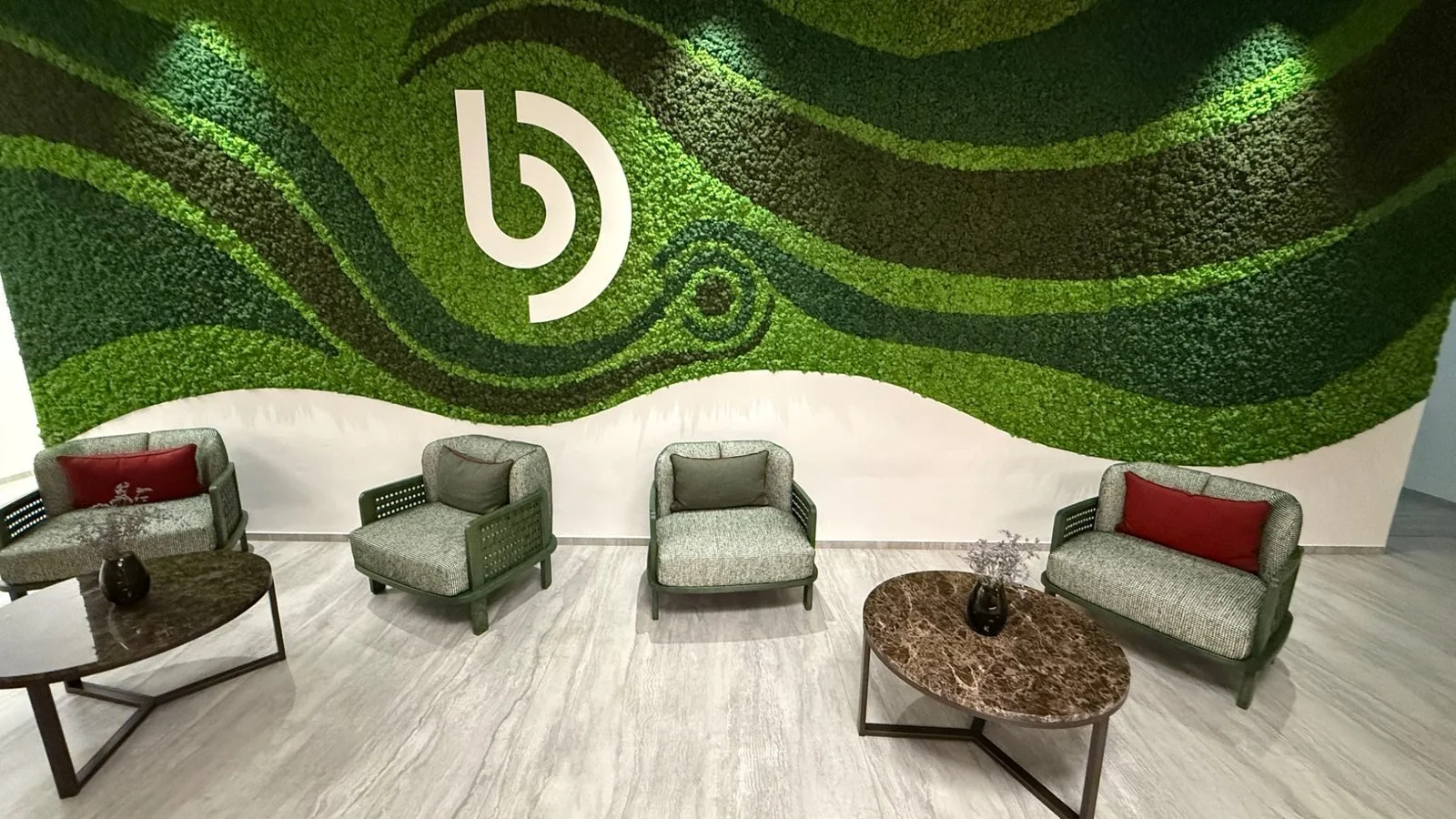 Lobby seating area and green living wall with the BUFF Medical Resort logo in Konstanz, Germany.