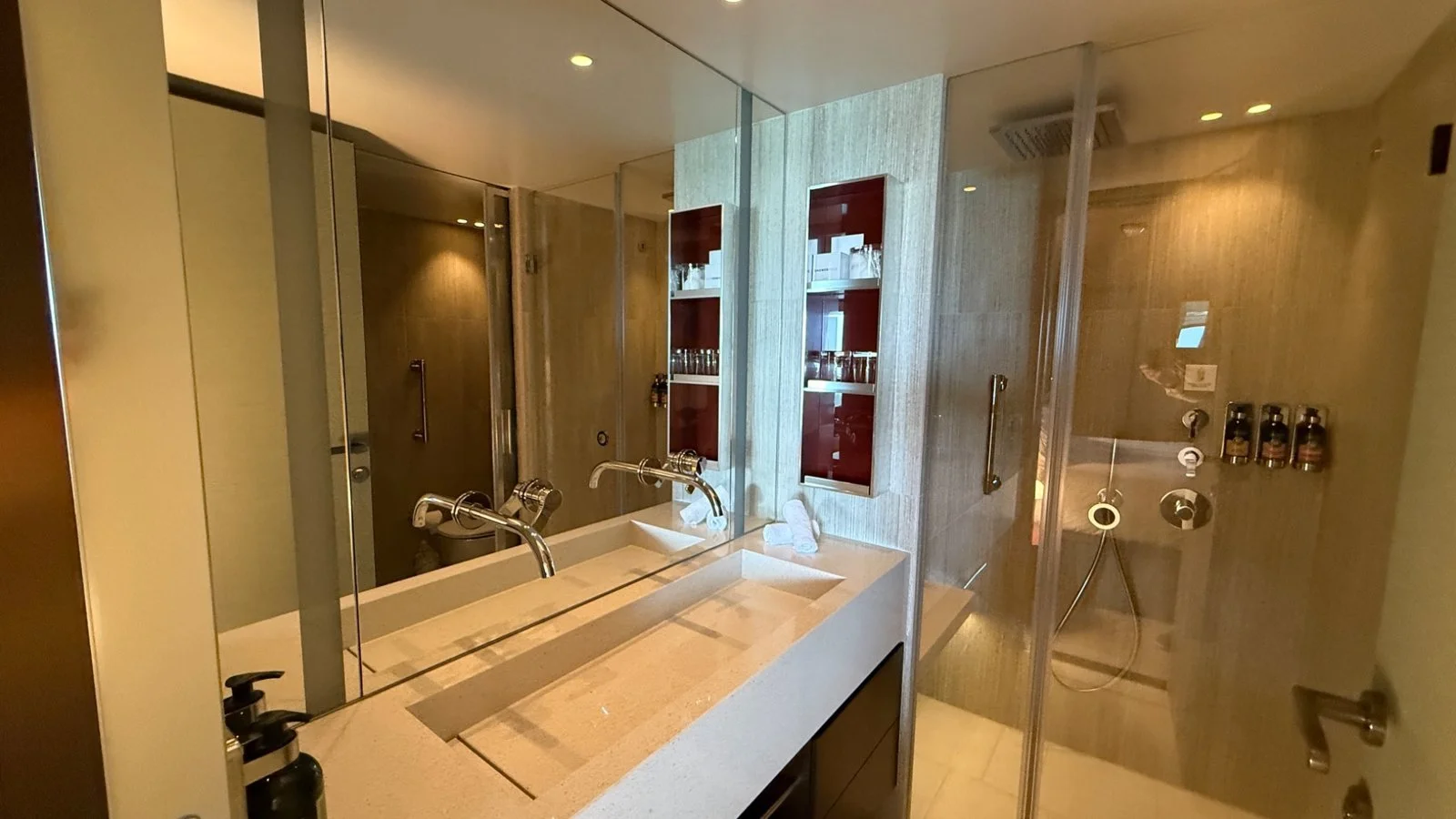 Luxury bathroom in The Haven suite on Norwegian Luna with double vanity and walk-in shower