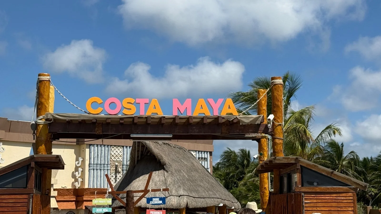 Costa Maya cruise port area with colourful shops, palm trees and pedestrian walkway in Mexico