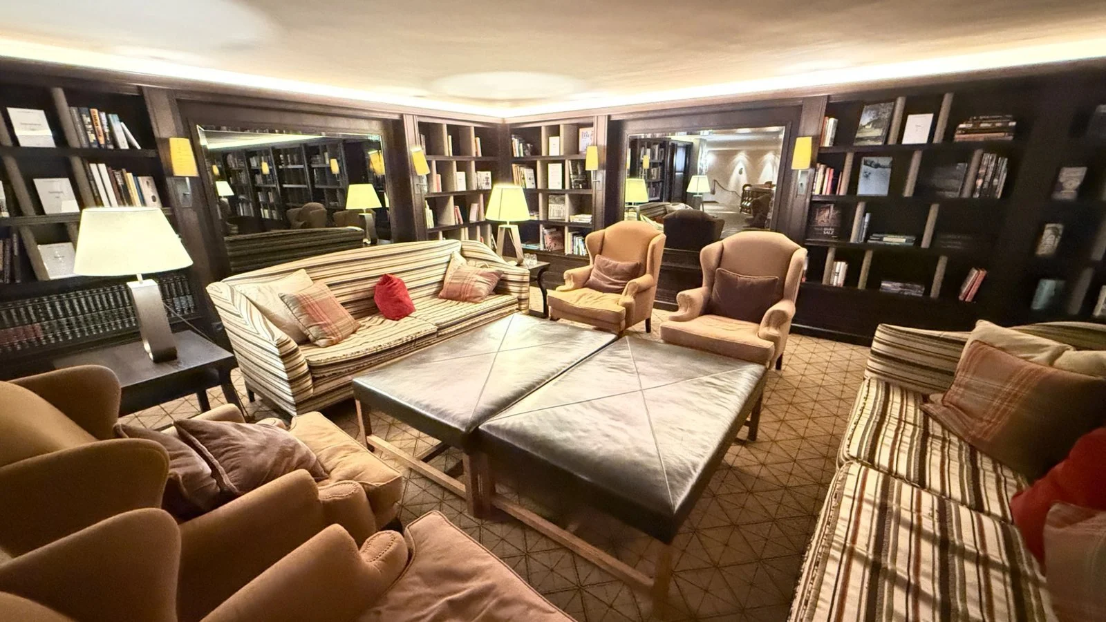 Cosy library lounge with armchairs at Interalpen-Hotel Tyrol