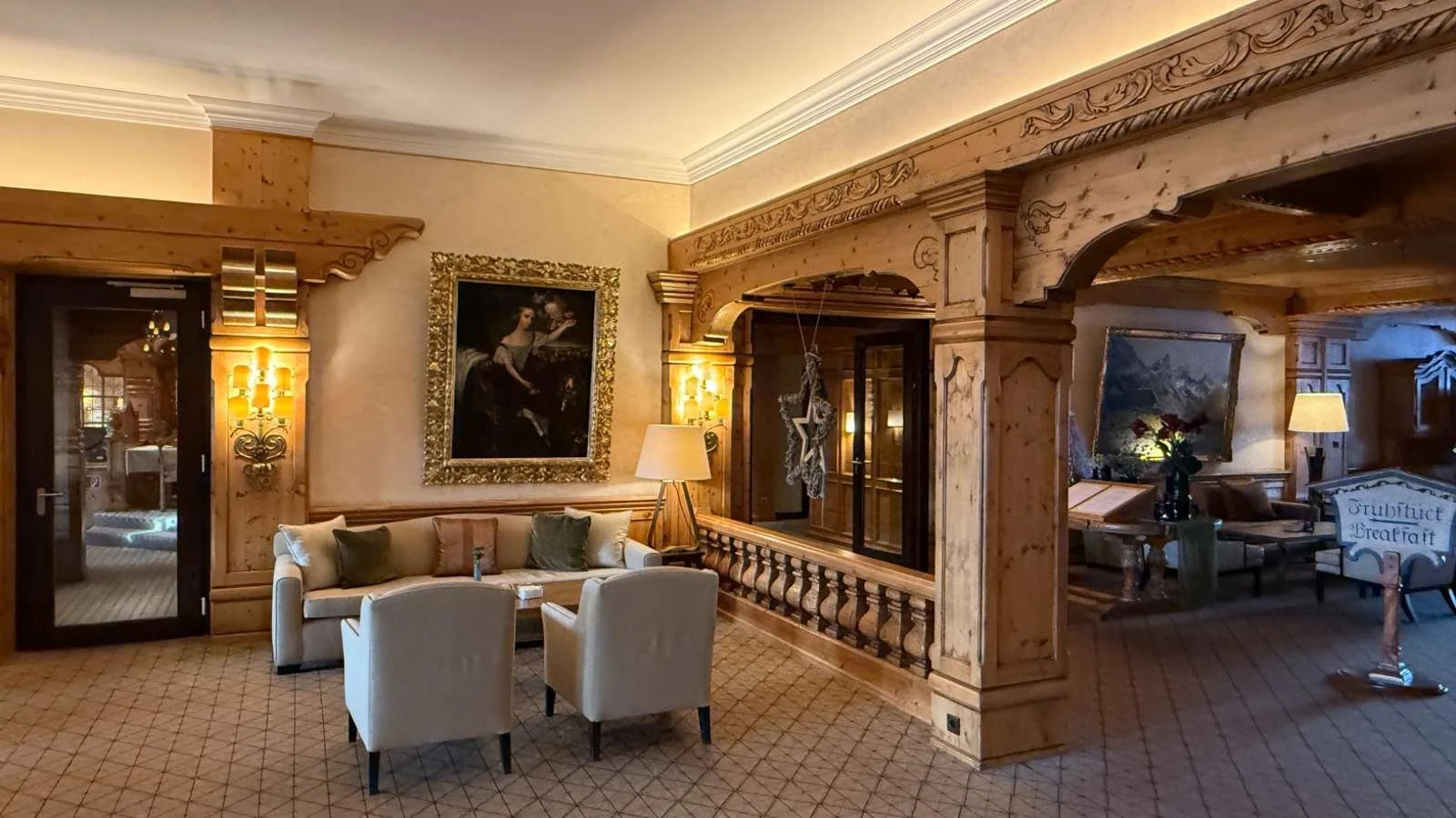 Traditional Alpine lounge with carved wooden interiors at Interalpen-Hotel Tyrol