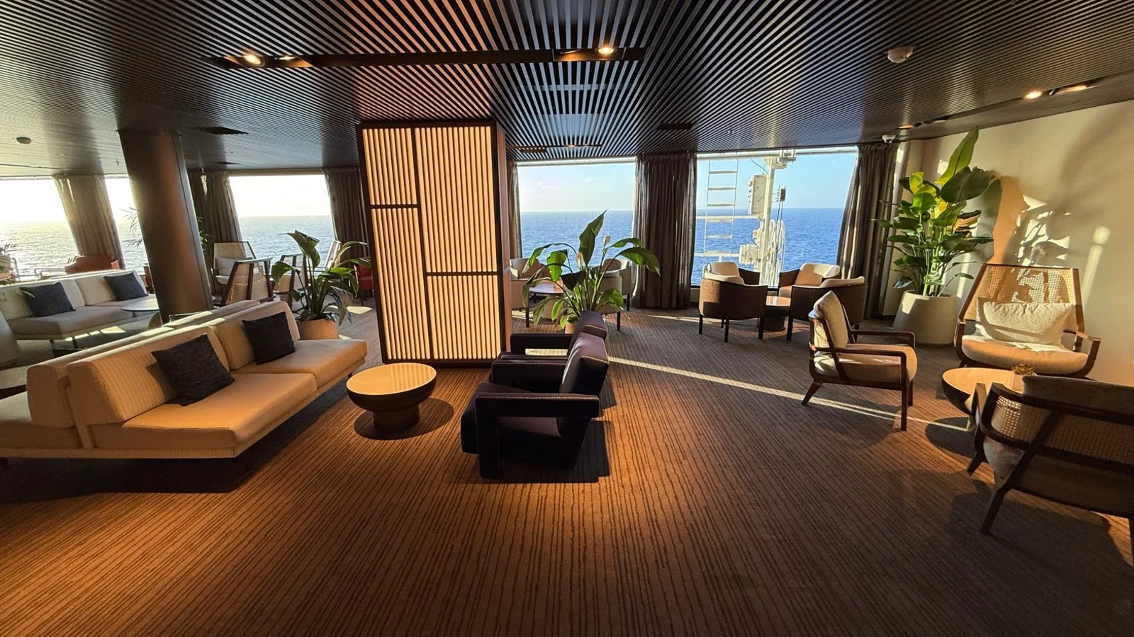 The Haven lounge aboard Norwegian Luna with ocean views and luxury seating during Caribbean sailing