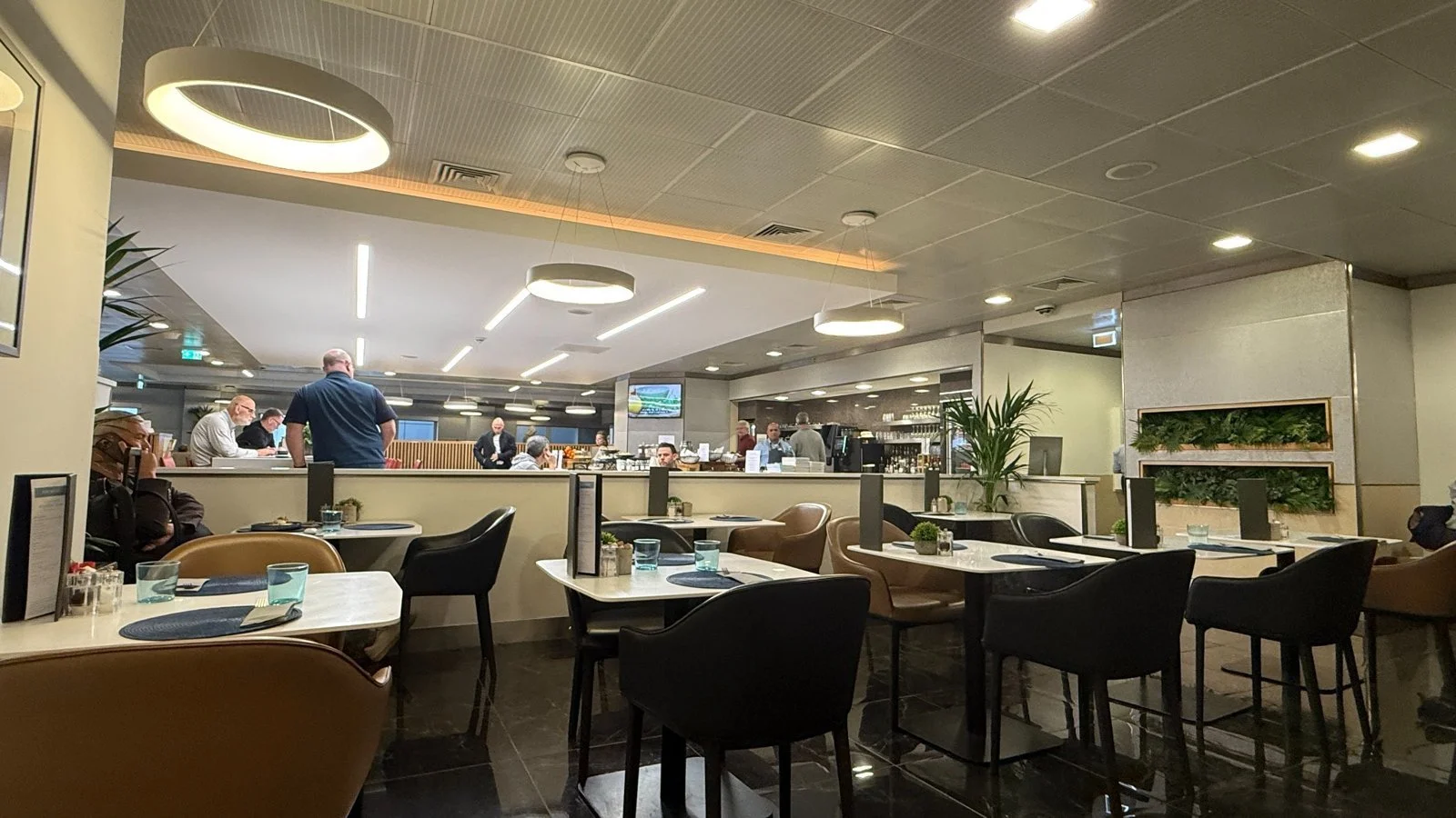 Heathrow Terminal 3 lounge seating area with dining tables and bar
