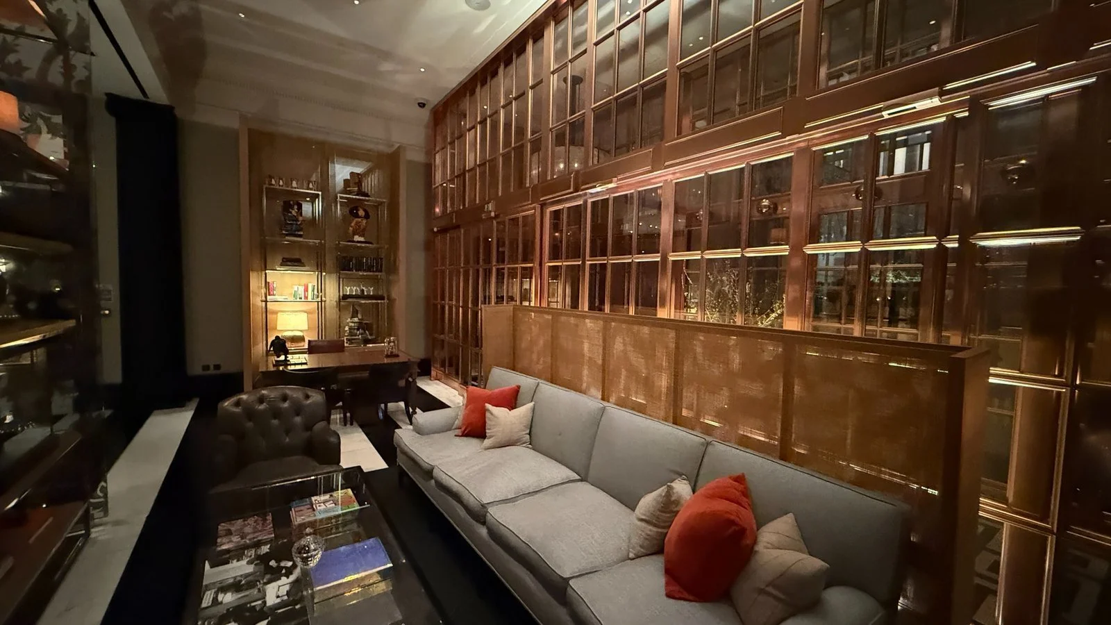 Library-style lounge with leather armchairs and wood panelling at Rosewood London