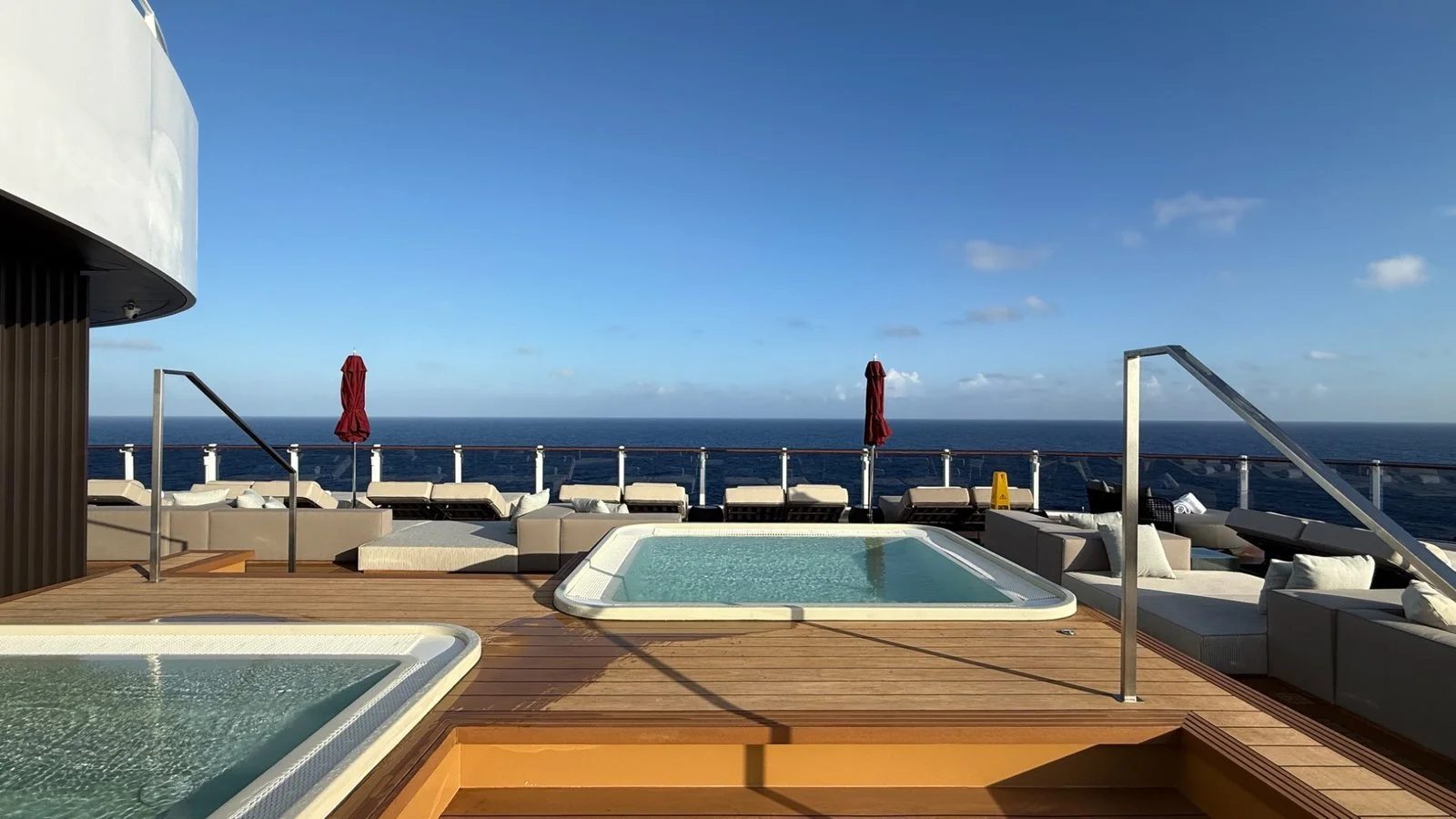 The Haven sundeck on Norwegian Luna with sunbeds overlooking turquoise ocean views