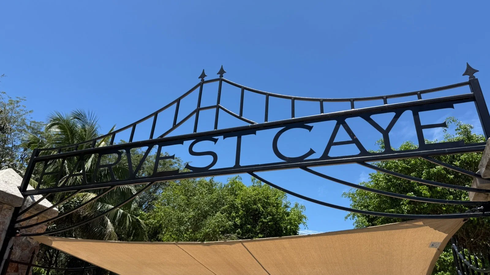 Entrance sign to Harvest Caye in Belize, Norwegian Cruise Line’s private island destination with tropical surroundings
