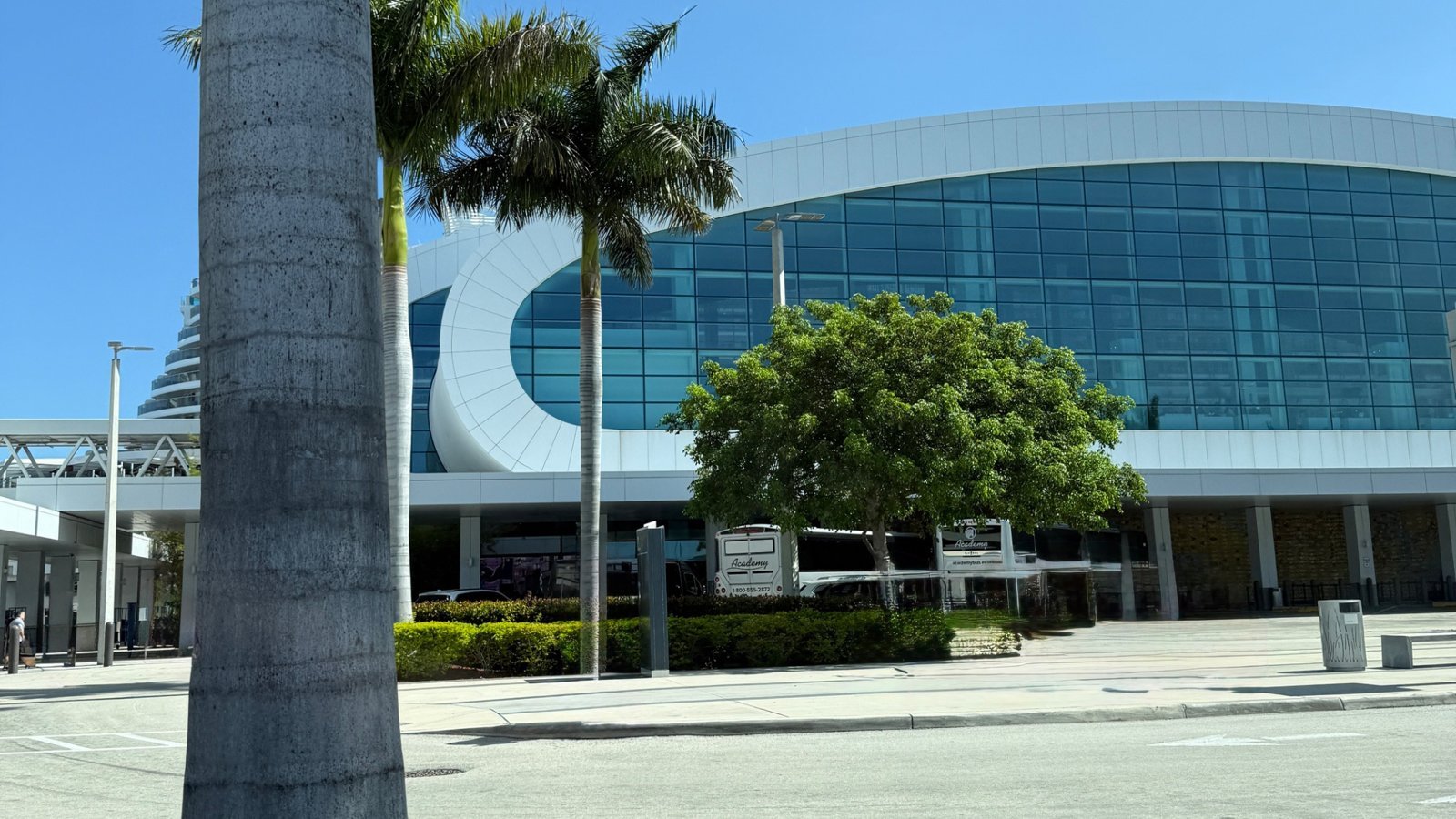 Modern cruise terminal at PortMiami with palm trees and glass façade, departure point for Norwegian Luna Caribbean sailing