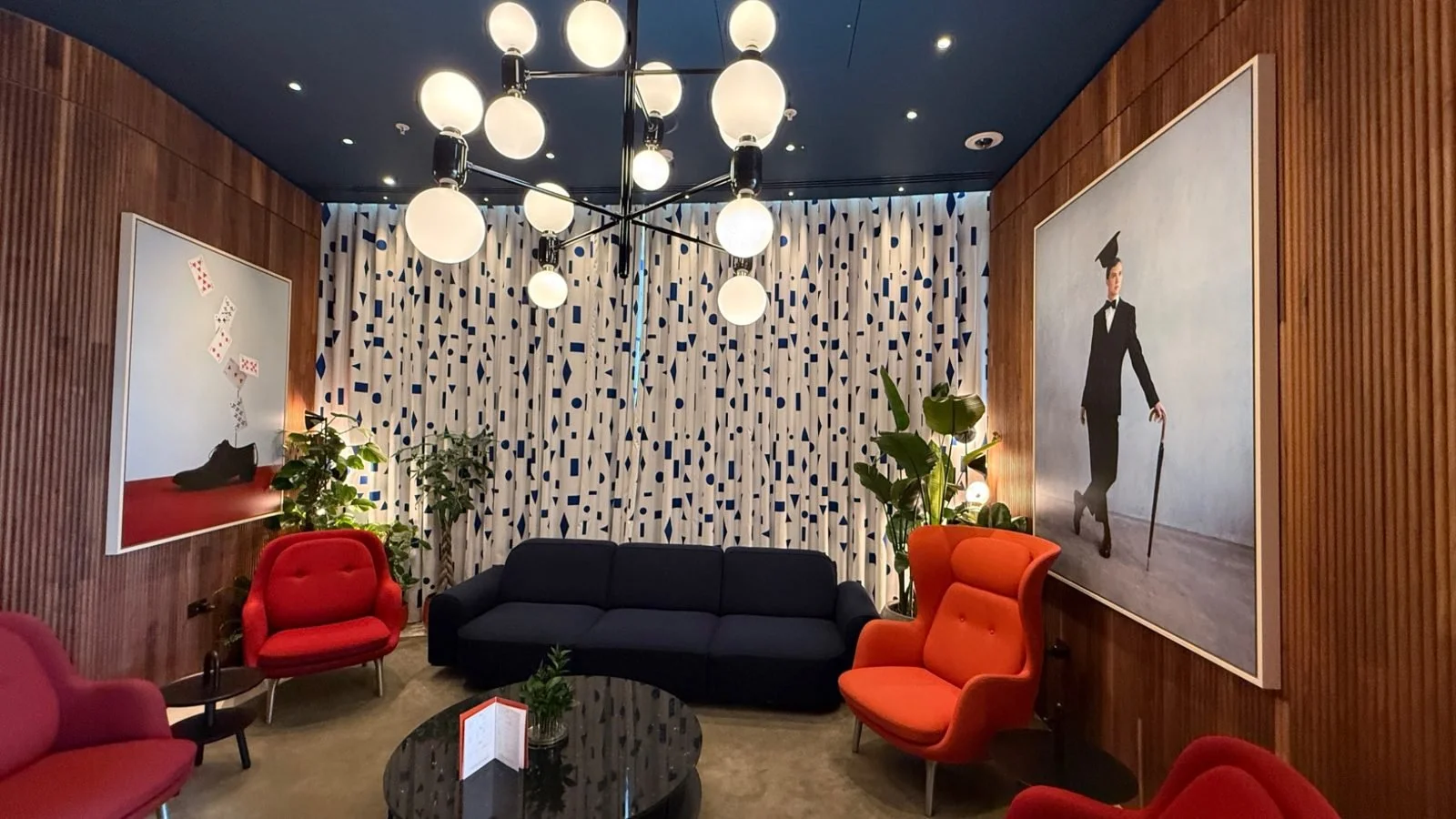 Stylish lounge seating area inside art’otel London Battersea Power Station with contemporary artwork and designer lighting