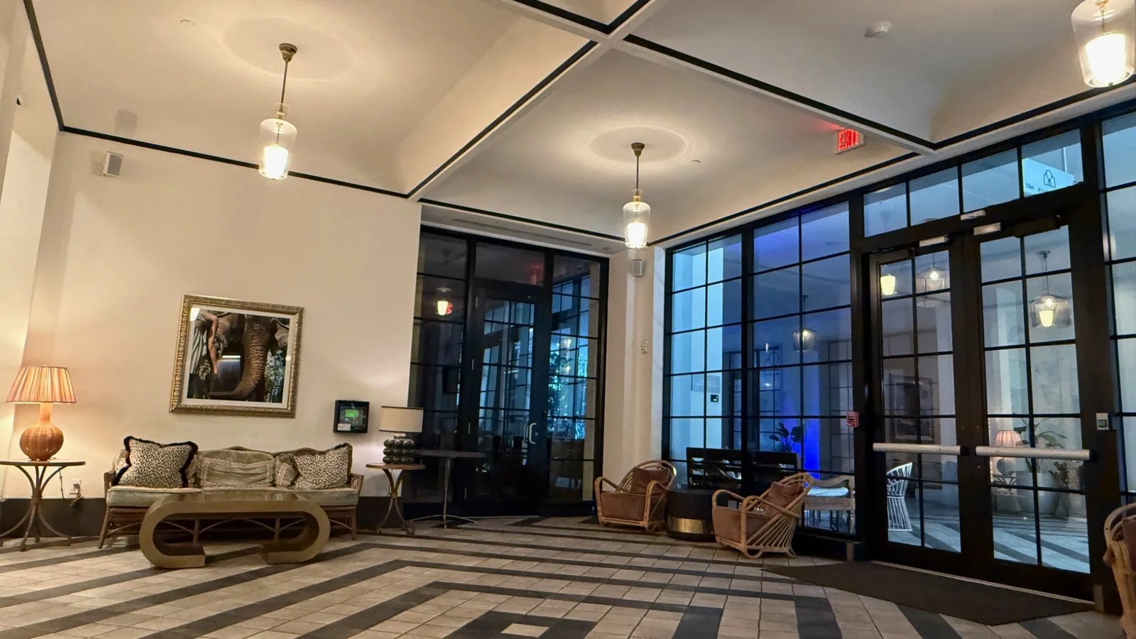Lobby seating area at The Goodtime Hotel Miami featuring vintage-style sofa, soft lighting and elephant artwork