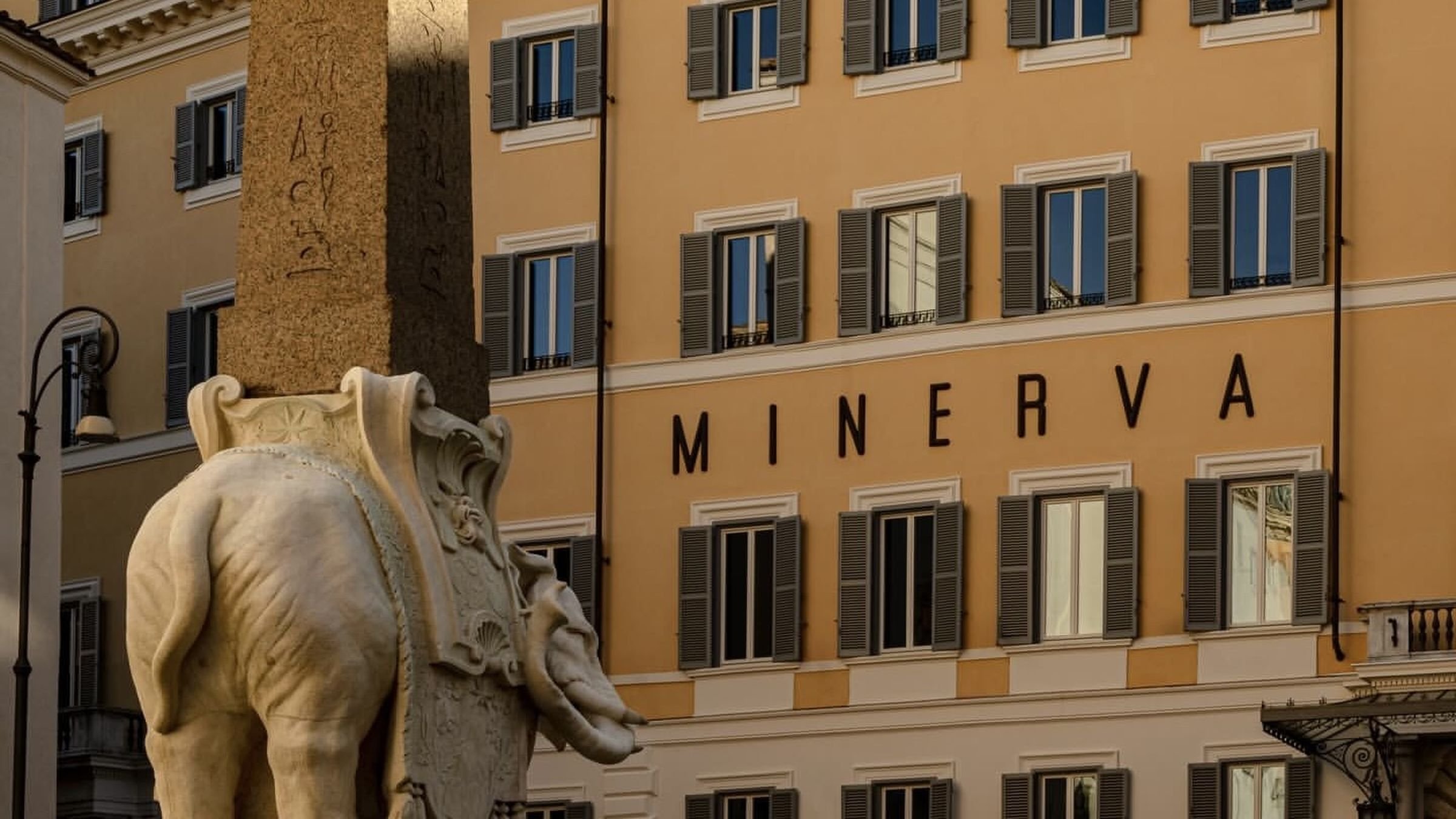 Exterior of Orient Express La Minerva overlooking Piazza della Minerva in Rome, with the historic elephant and obelisk sculpture in the foreground.