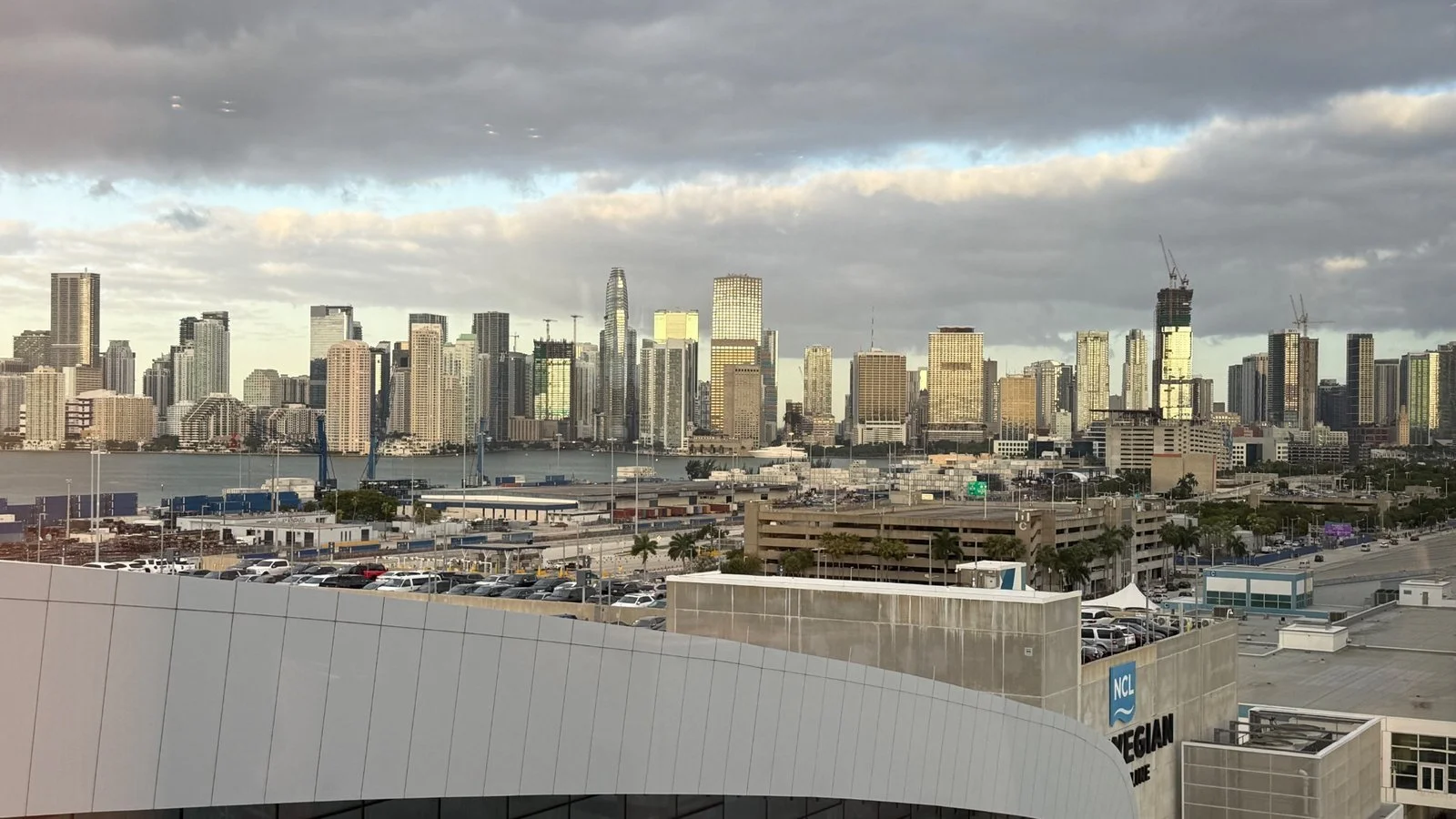 Miami skyline viewed from PortMiami with cruise terminal buildings and Biscayne Bay in the foreground