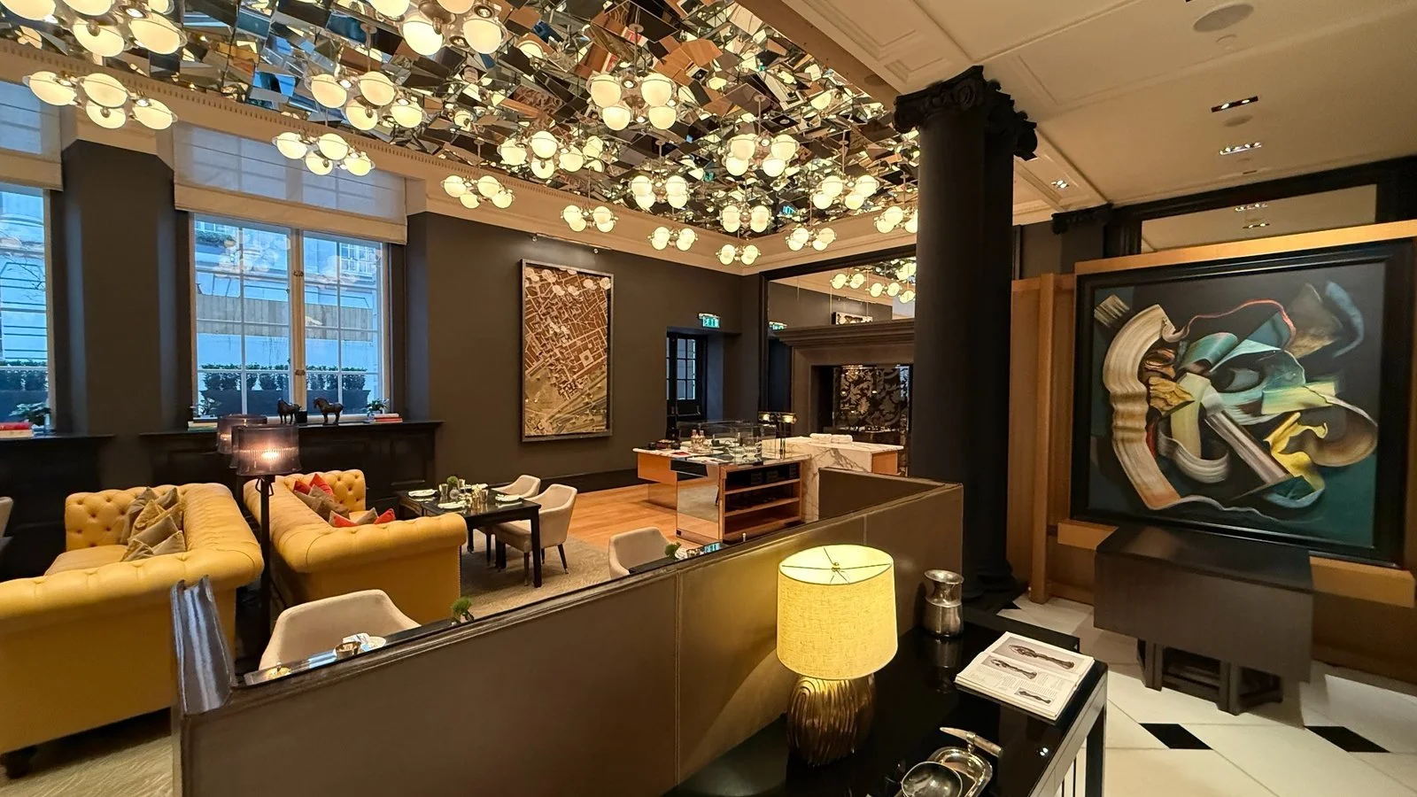 Lounge with mirrored ceiling and chandelier lighting at Rosewood London