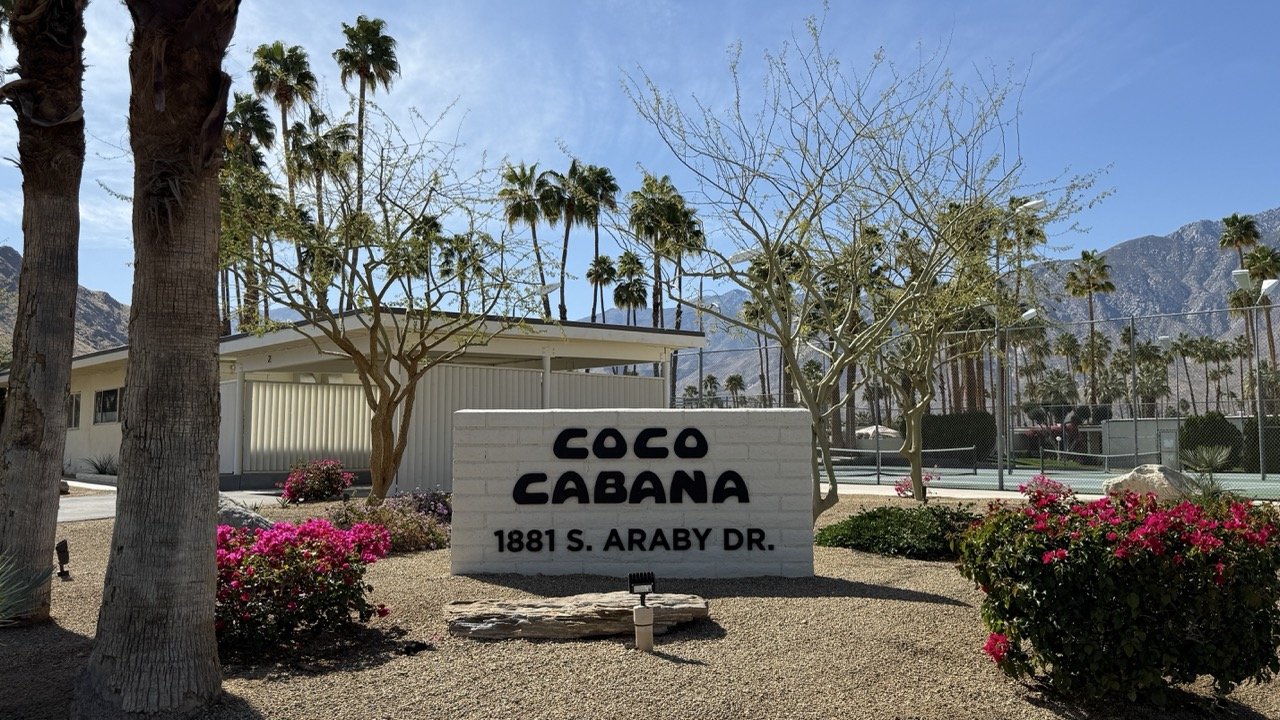Coco Cabana entrance sign at 1881 S. Araby Dr, Palm Springs, with a mid-century modern aesthetic and mountain backdrop.