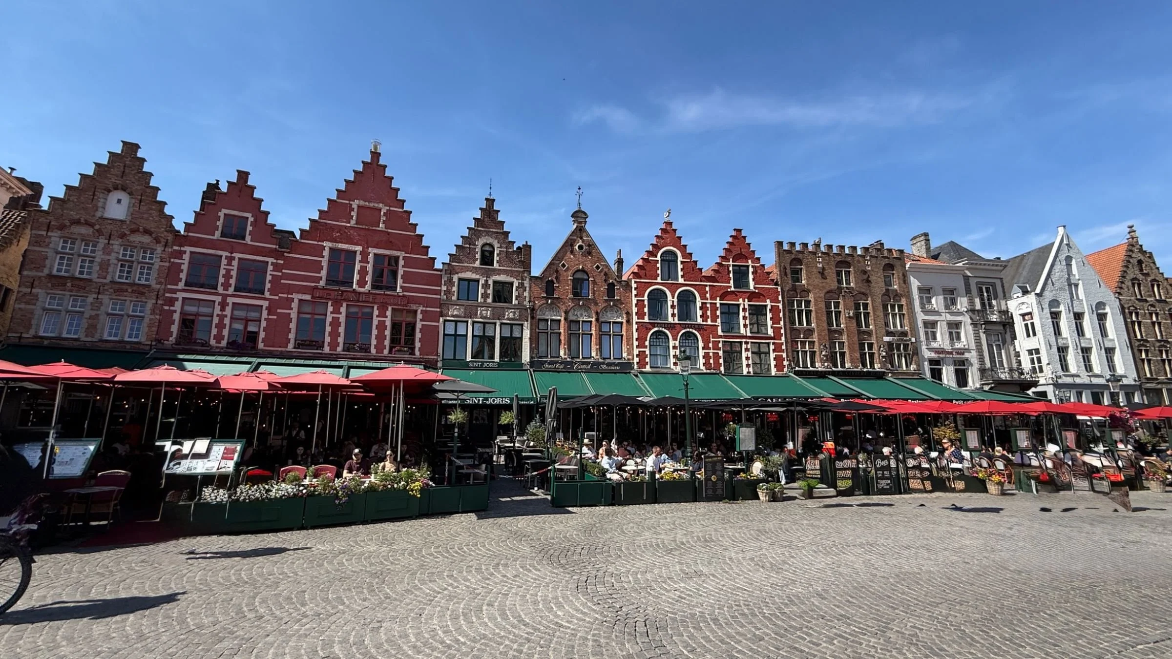 Historic guild houses lining Bruges Market Square.