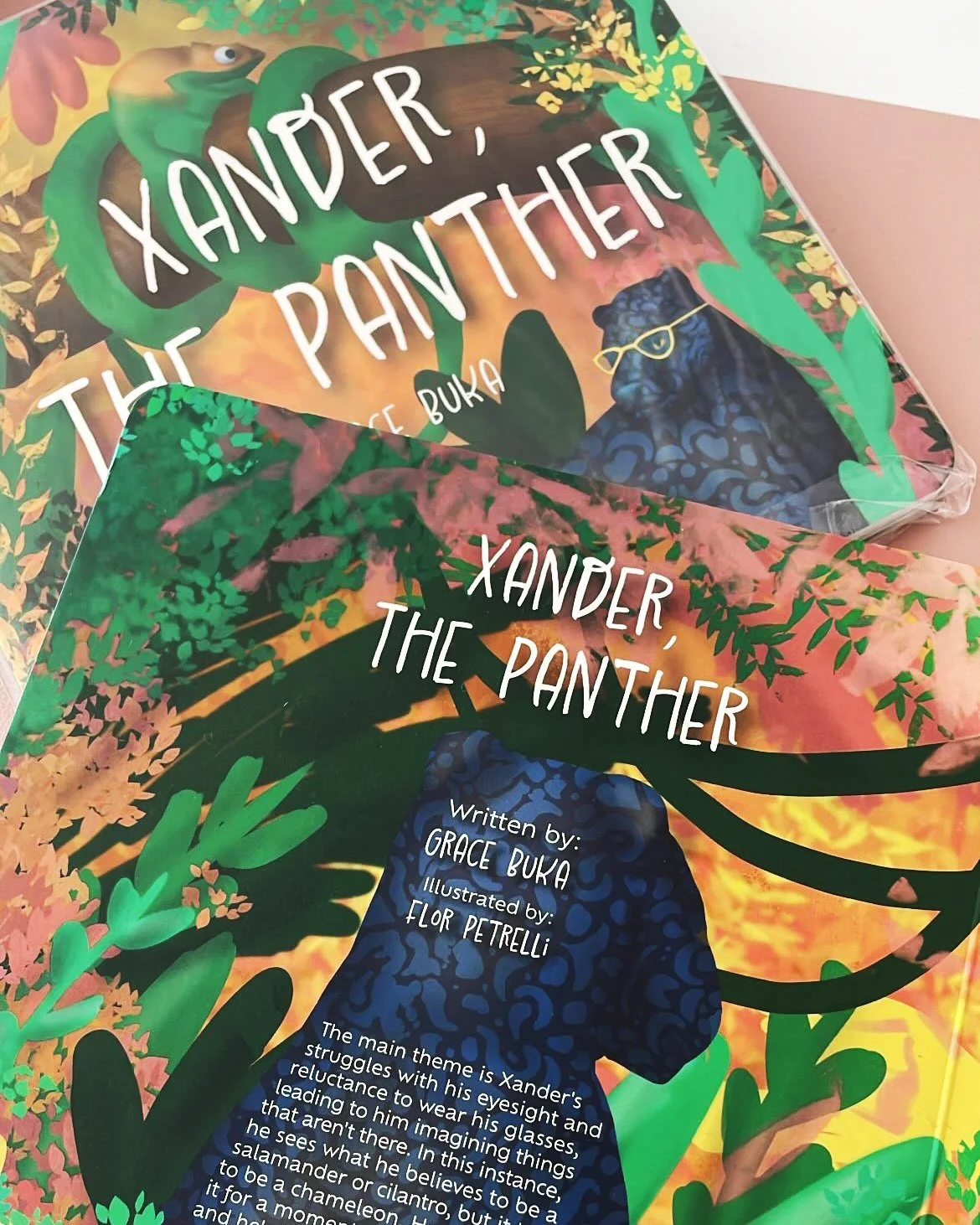 Colorful illustrated cover of a children's book titled 'Xander, the Panther' by Grace Buka, illustrated by Flor Petrelli, featuring a panther wearing glasses amid lush green and pink jungle foliage.
