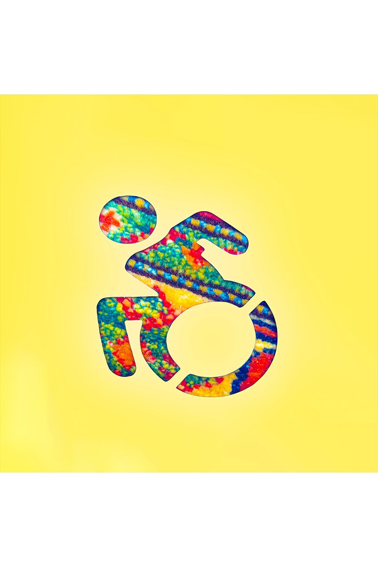 New accessibility symbol (person racing in a wheelchair) with background is and filled with colors and texture from an Afghan rug
