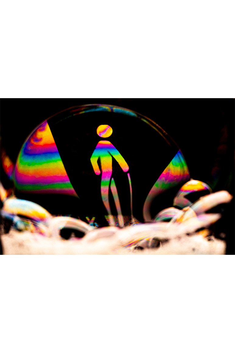 Colorful bubble with the blind/low vision symbol of a person with a cane. The legs and cane are elongated because of the contour of the bubble.