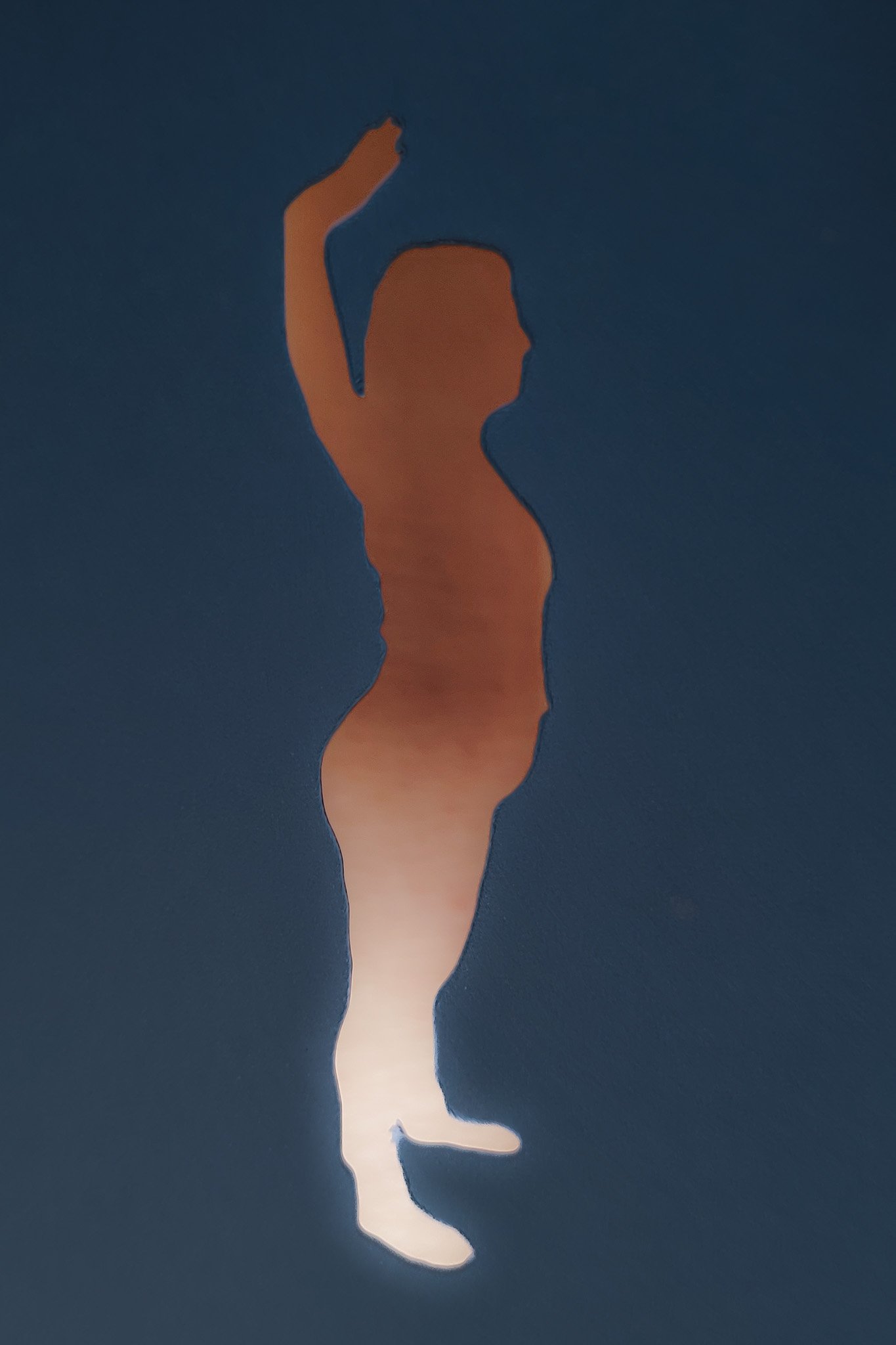Just Skin: A full body stencil of Jessica in profile standing in second position and a hand over her hand. The photo is of her skin filling the stencil, the skin is edited to be a gradation of medium browns at the top to almost white at the bottom