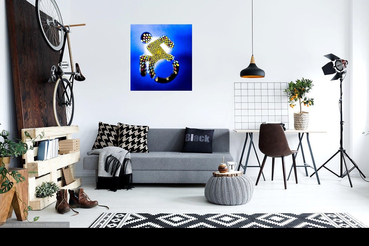 A living room with the photo Climate Change and Accessibility: The Intermediation Accessibility Symbol filled with the Sustaining All Life logo, resembling a sunflower's center in a vibrant Fibonacci pattern.