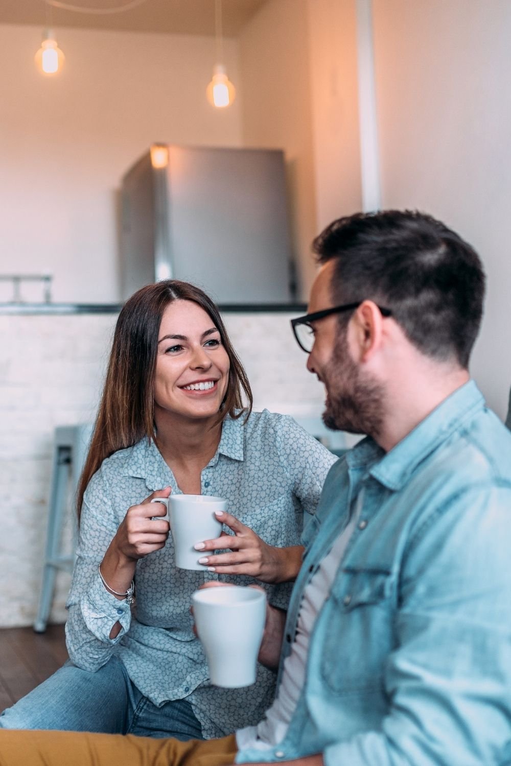 Young couple drinking coffee together and chatting