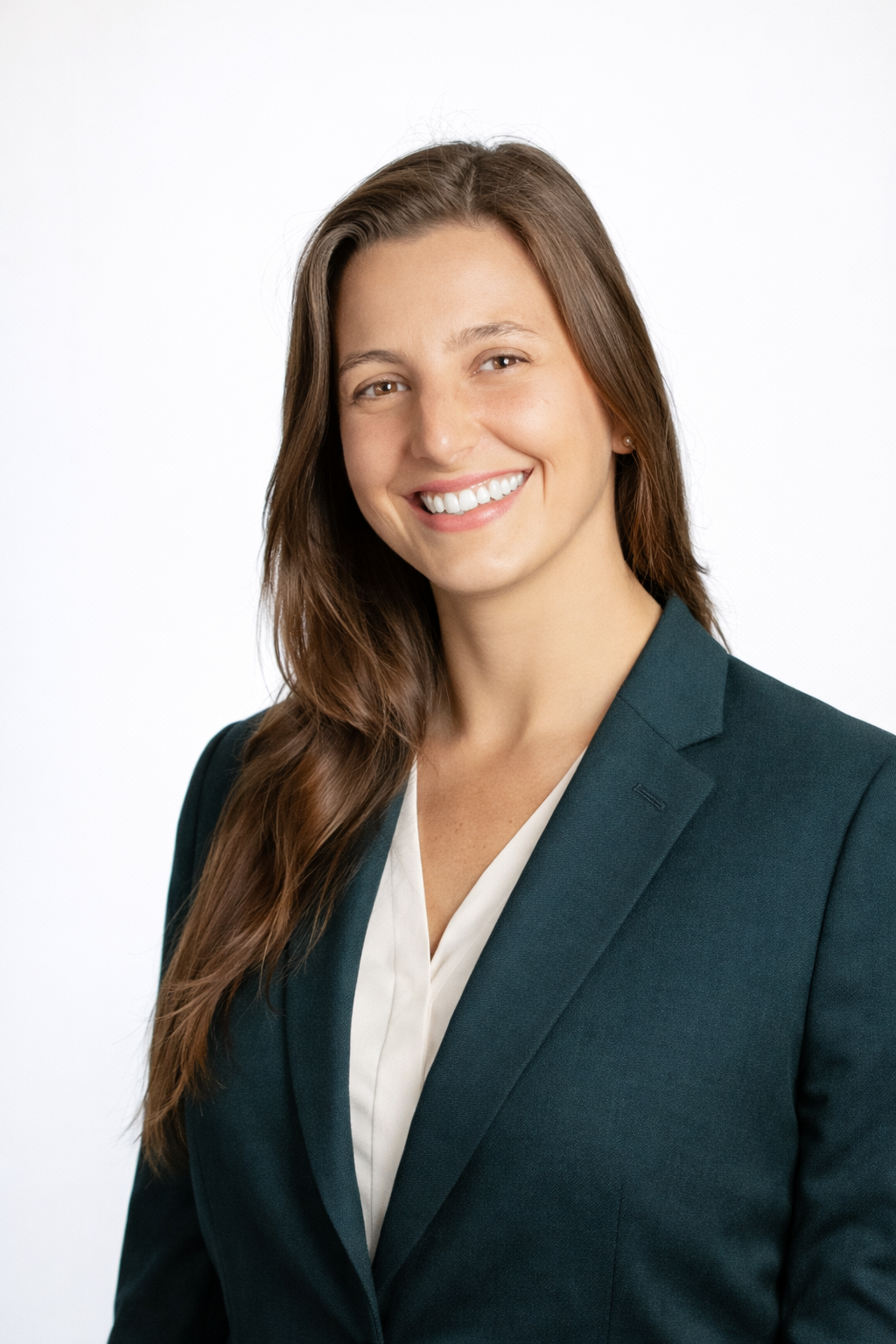 Headshot of a smiling man with a shaved head, wearing a dark shirt and a beaded necklace, against a white background.