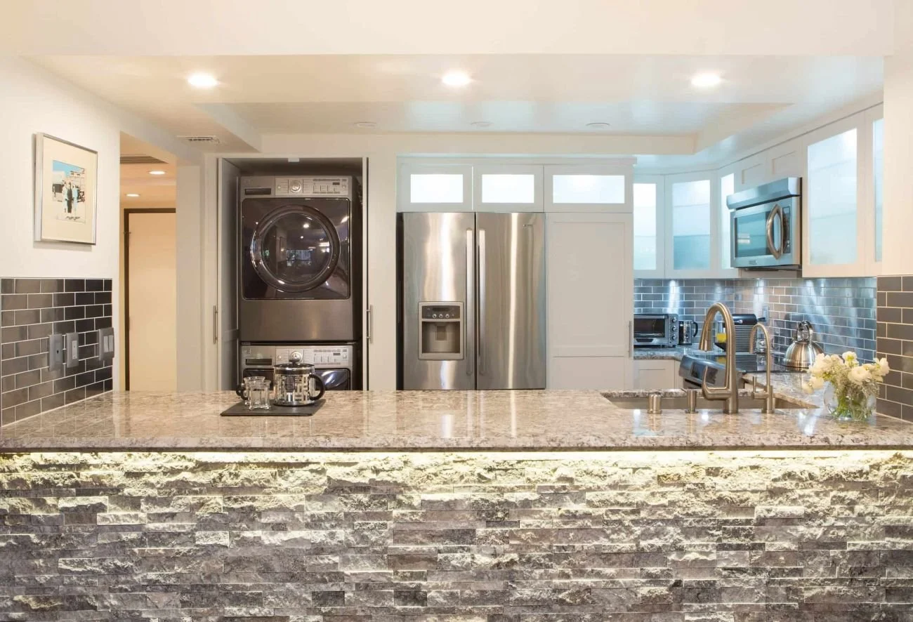 white shaker kitchen with stackable washer and dryer, Wilshire Corridor