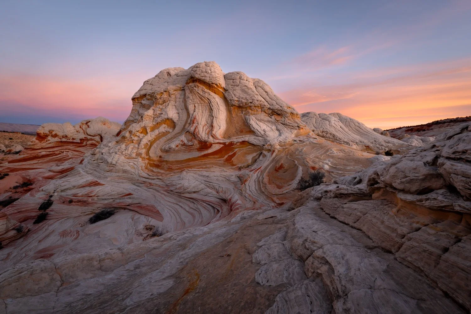 Colorful swirling rock formations at sunset.