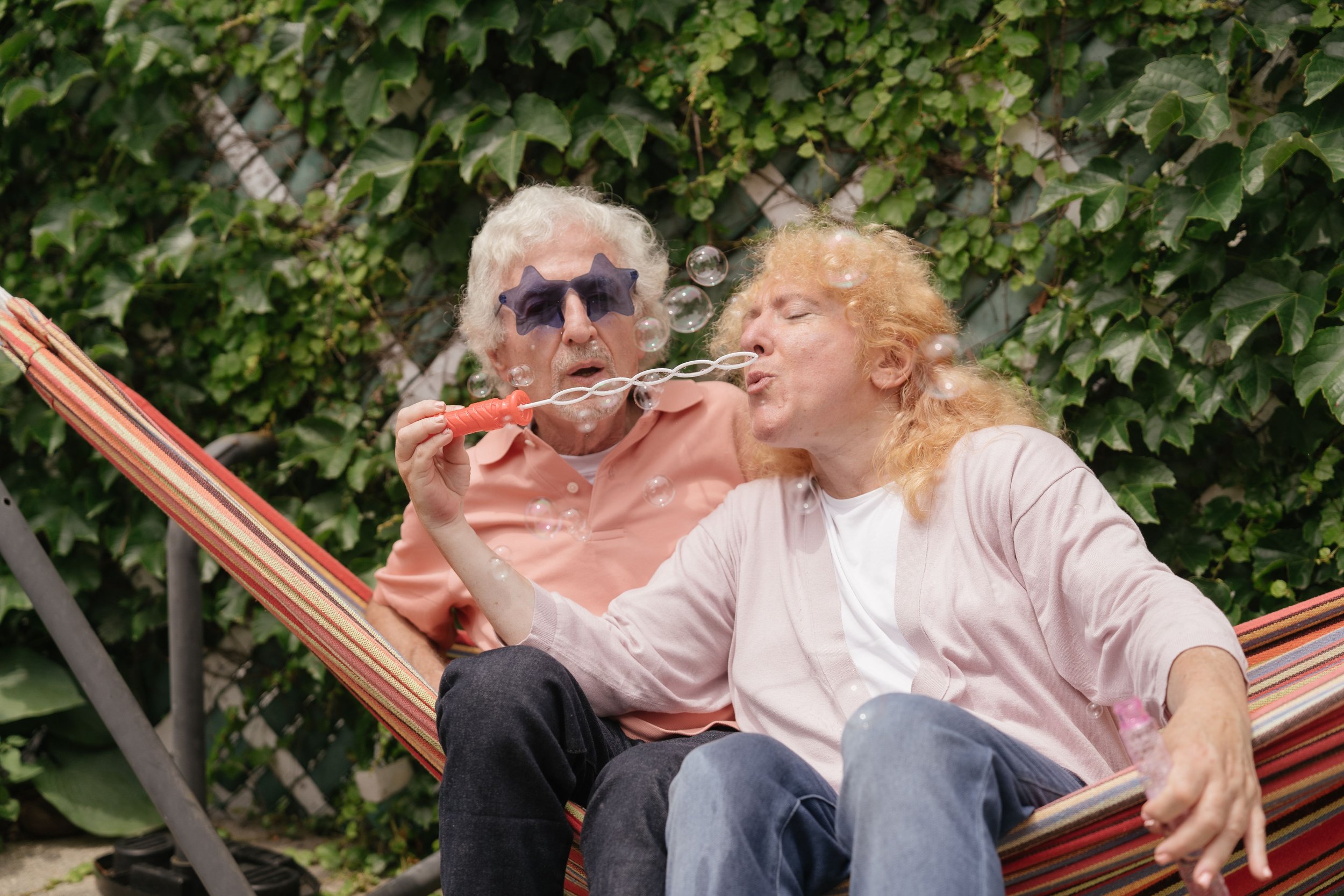 Older white male and female couple enjoying relaxation together on a hammock, learning to connect through marriage counseling Worcester.