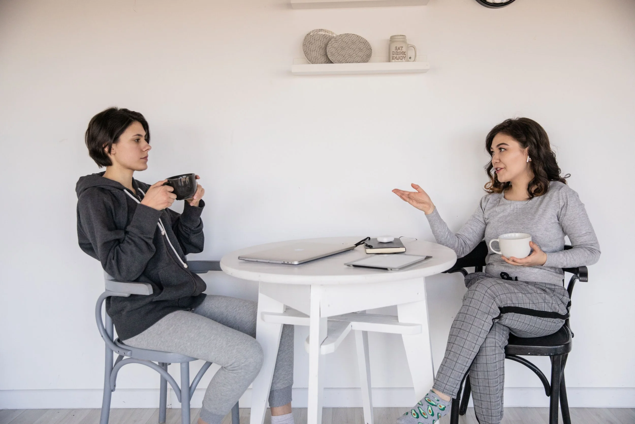 Two women sitting at a table talking with each other at Couples Therapy Massachusetts.
