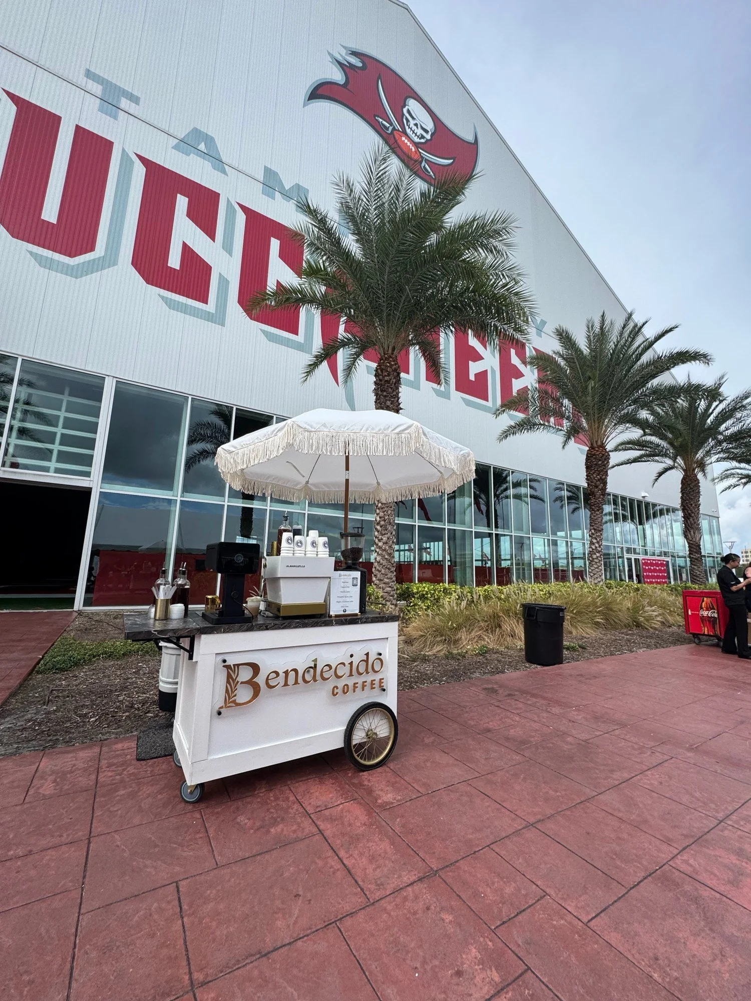 Bendecido Coffee cart serving outdoors by a Buccaneers tent in Westshore, Tampa