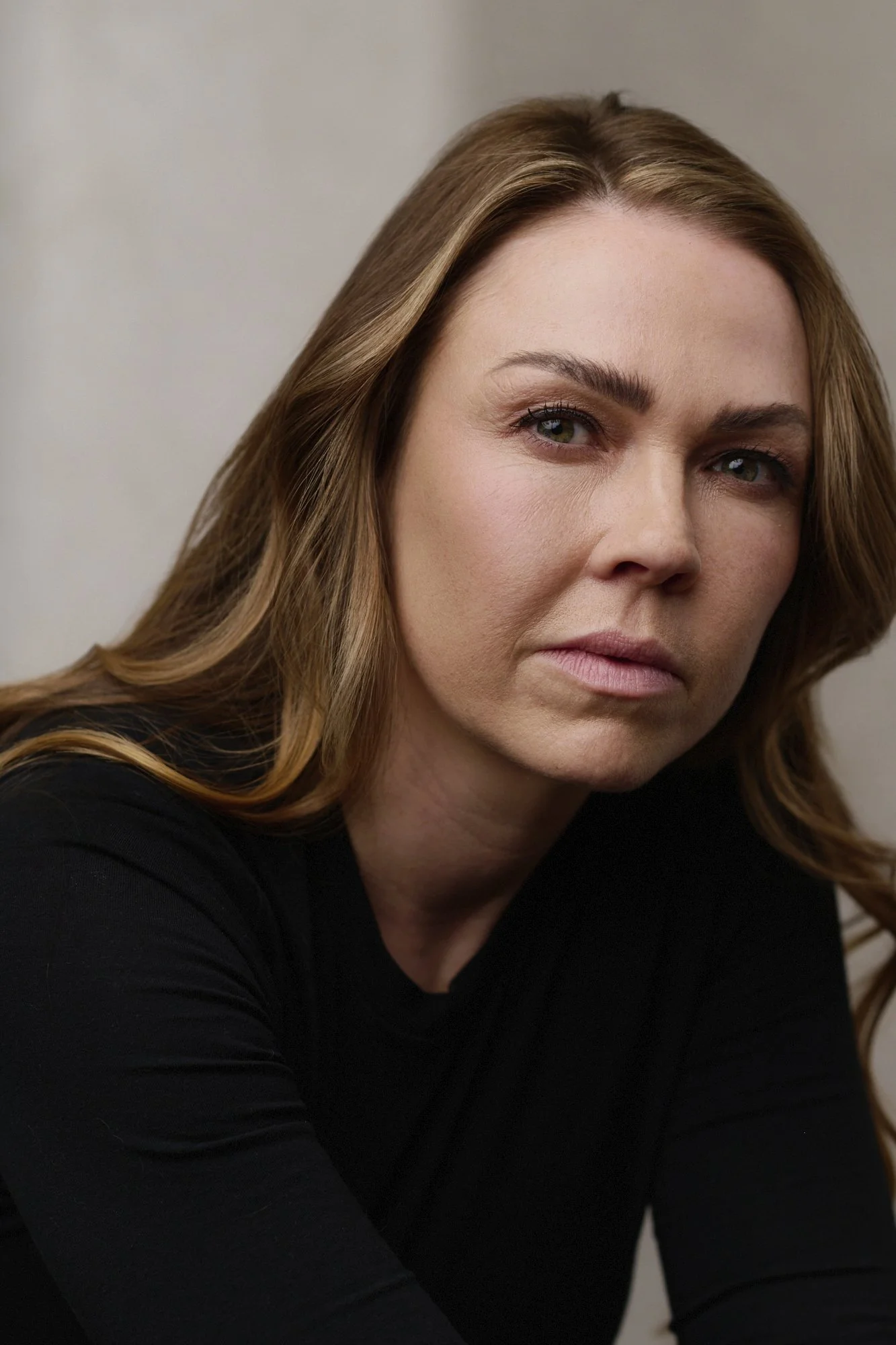 Minimal studio headshot of Adele Silva looking directly at camera