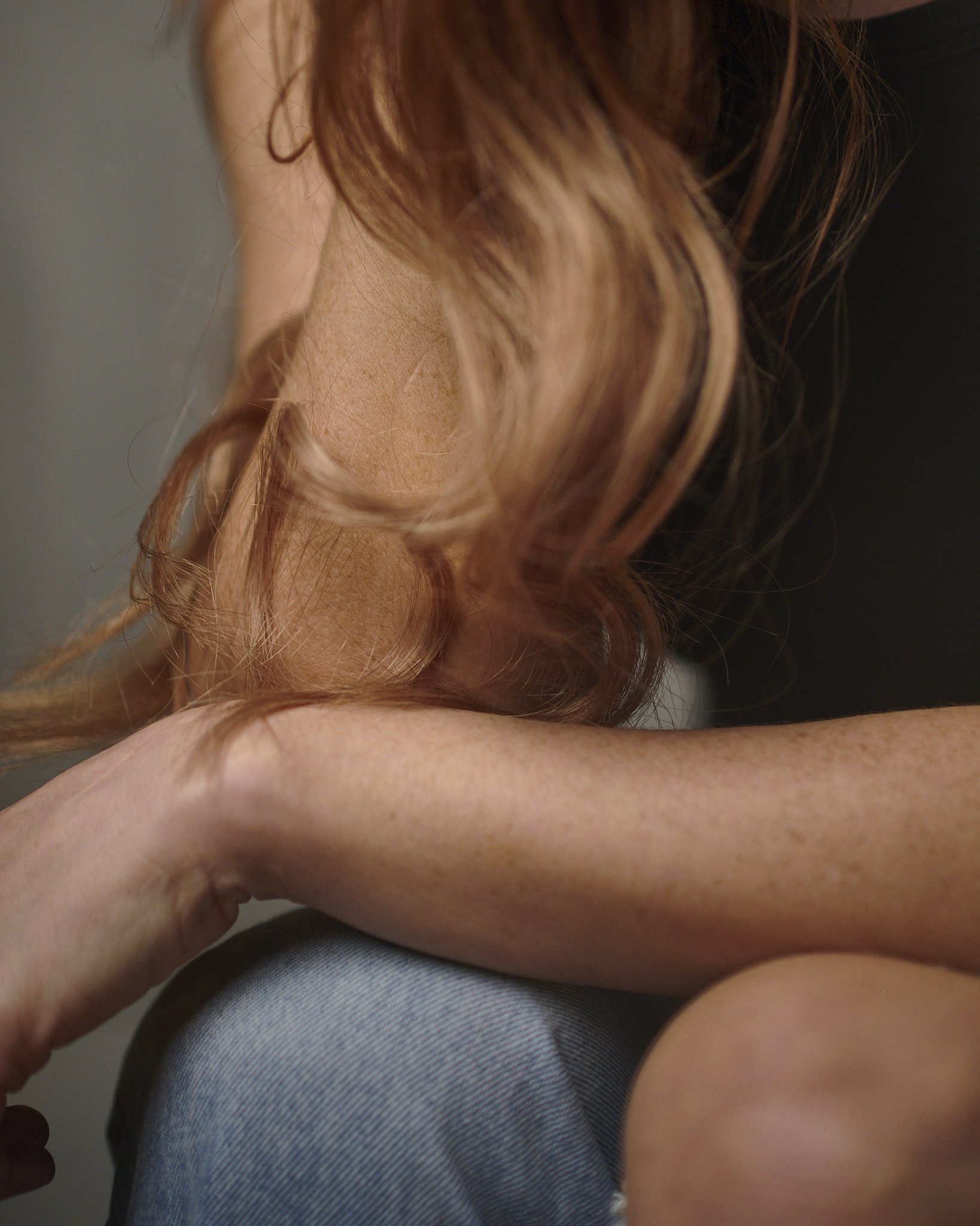 Close-up portrait of actor Hollie-Jay Bowes looking toward window light in studio