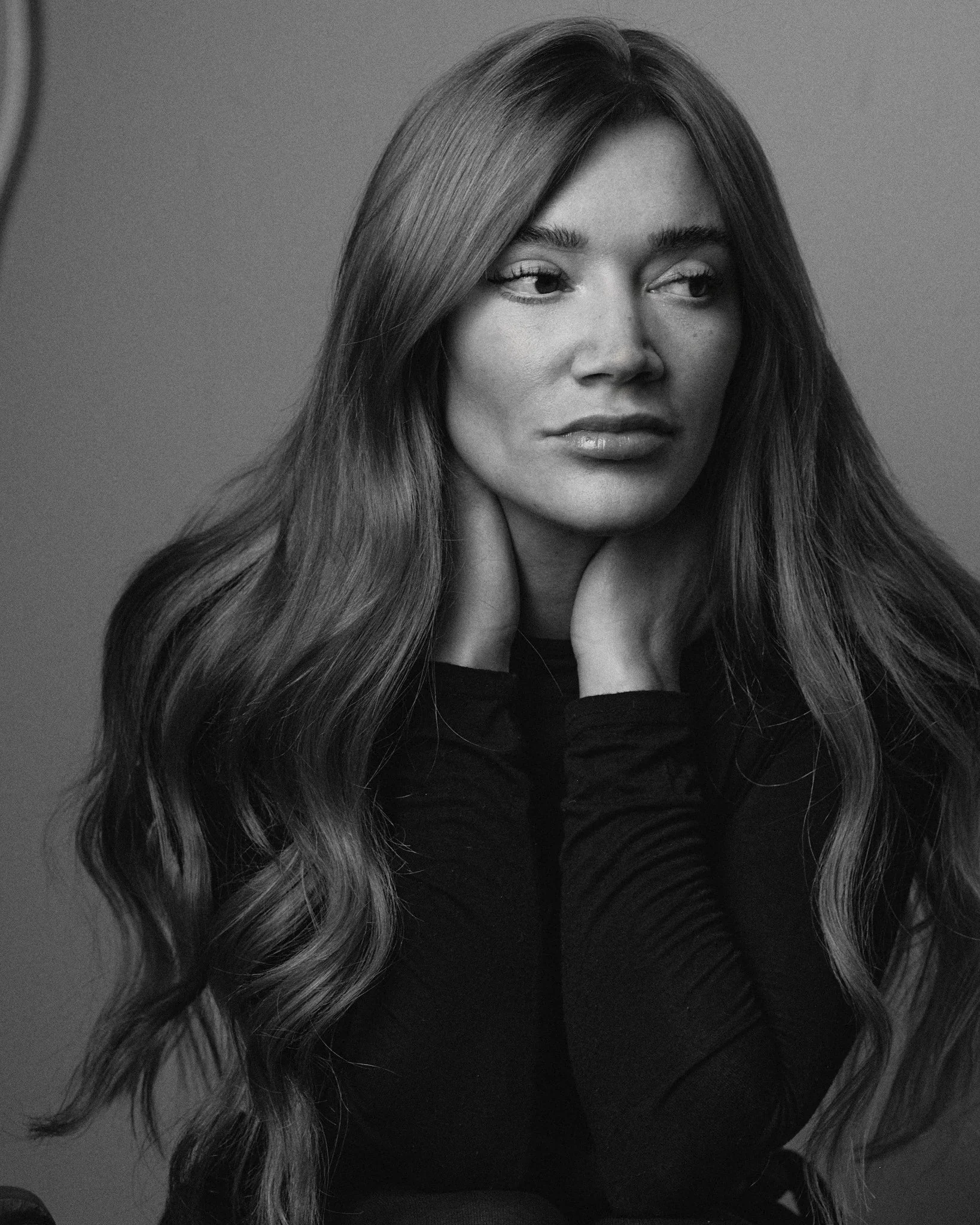 Natural light portrait of Hollie-Jay Bowes against minimal studio backdrop