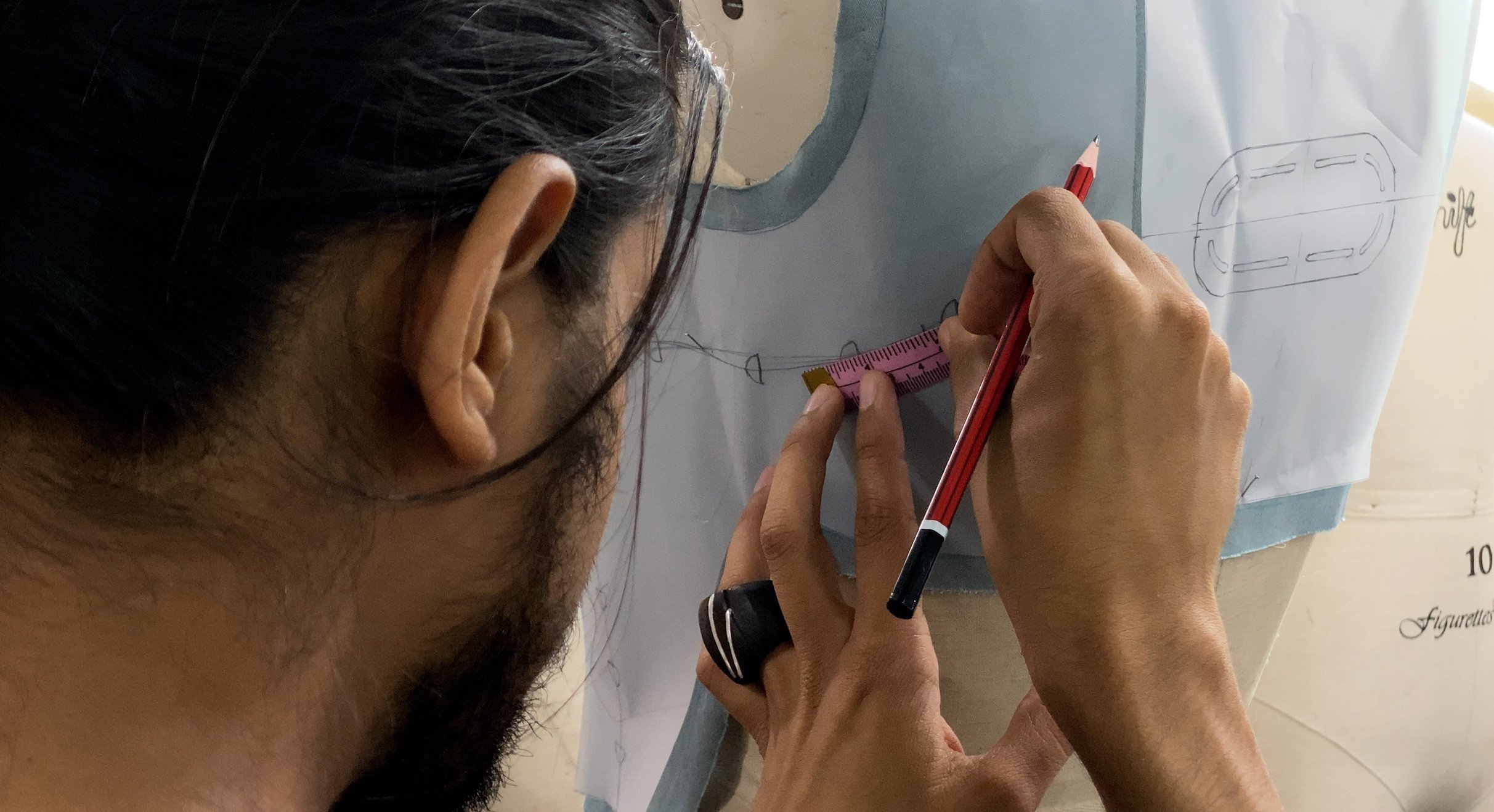  Shiv marking up embroidery lines.   New Delhi, 2023. 