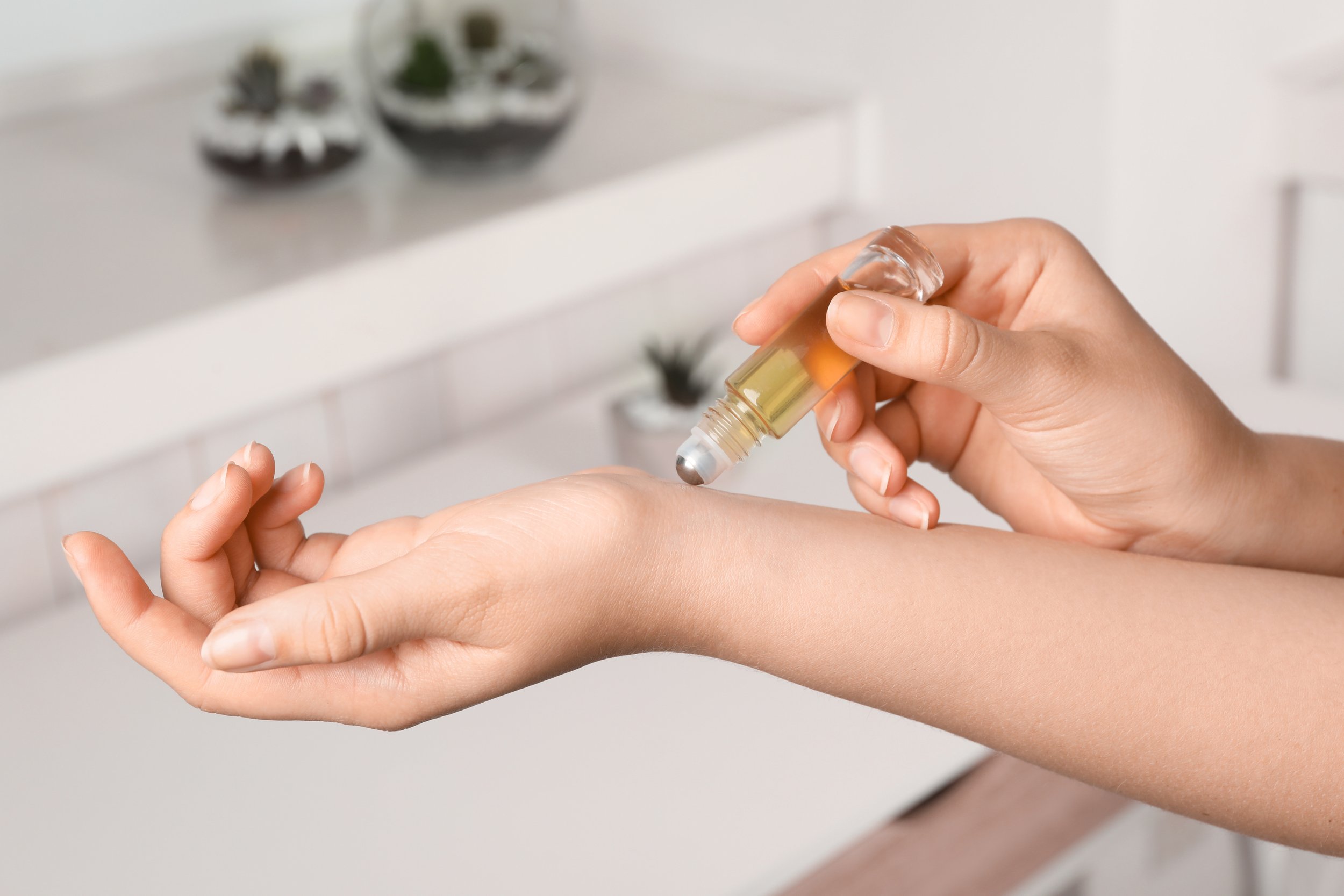 applying essential oil roller blend on wrist