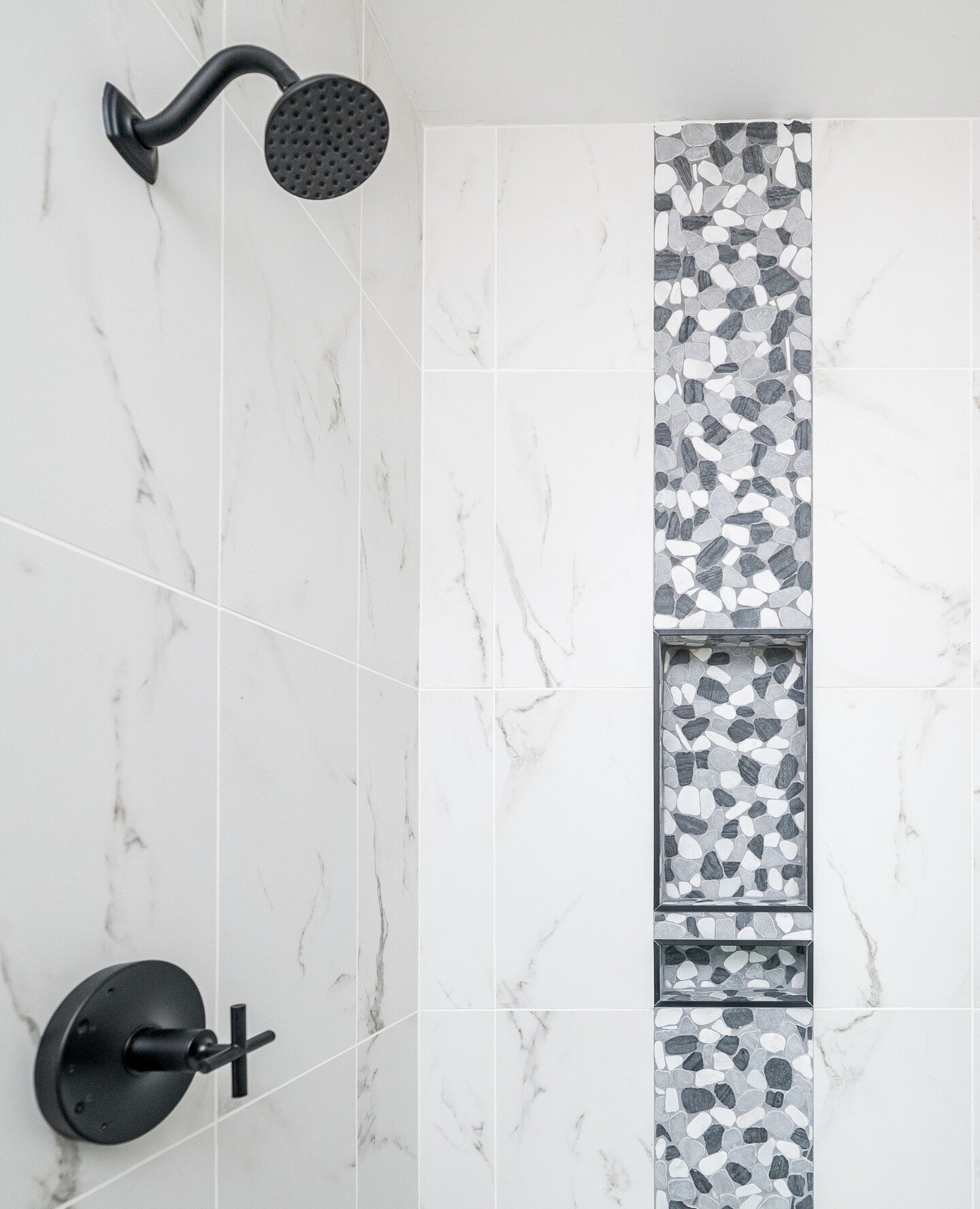 We selected an elegant grey and white color palette that creates a sophisticated and timeless look for this primary bathroom. The combination of textures adds depth and visual interest, making every shower experience feel like a spa retreat. Ready to