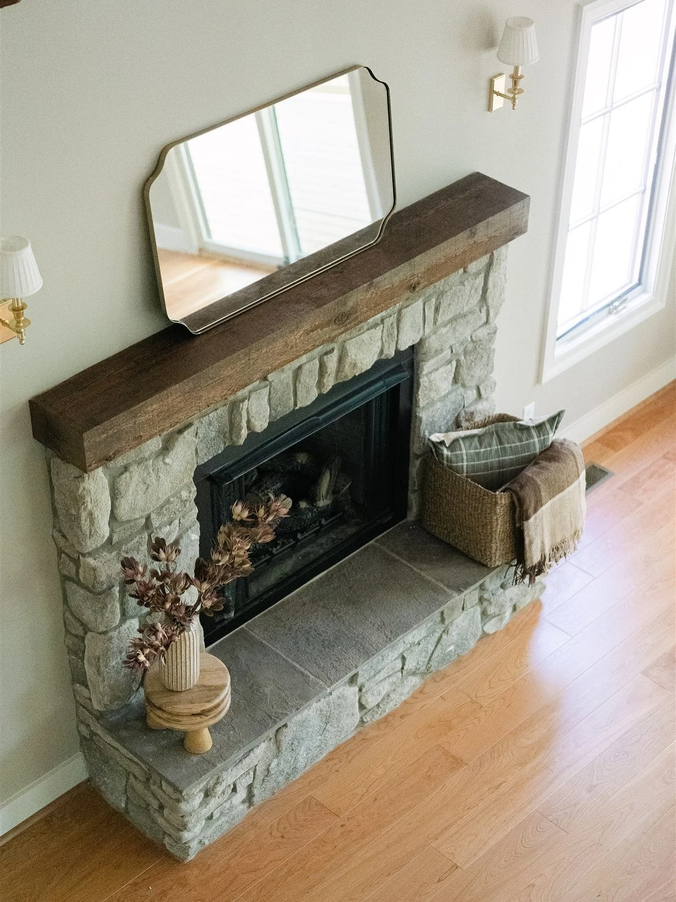 Fall is here, and cozy evenings by the fire are calling. 🍂✨ This stone fireplace brings all the moody texture and warmth, grounded by a rustic wood mantel that makes the whole space feel inviting. Add a few seasonal touches, like a throw blanket or 