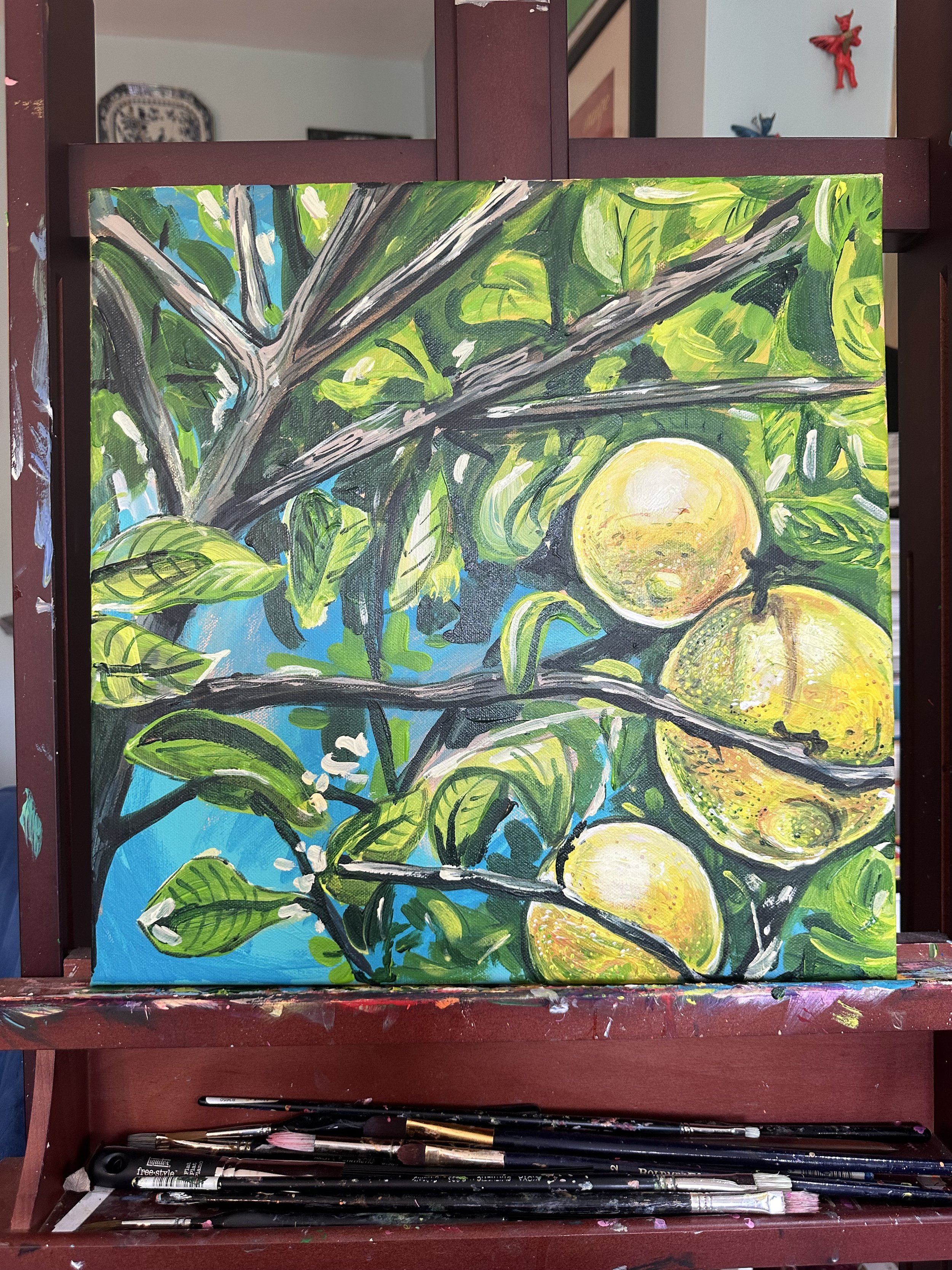 Lucy Caddel artist bright colourful acrylic artwork painting Lemons Mallorcan grove Mallorca on easel.jpeg