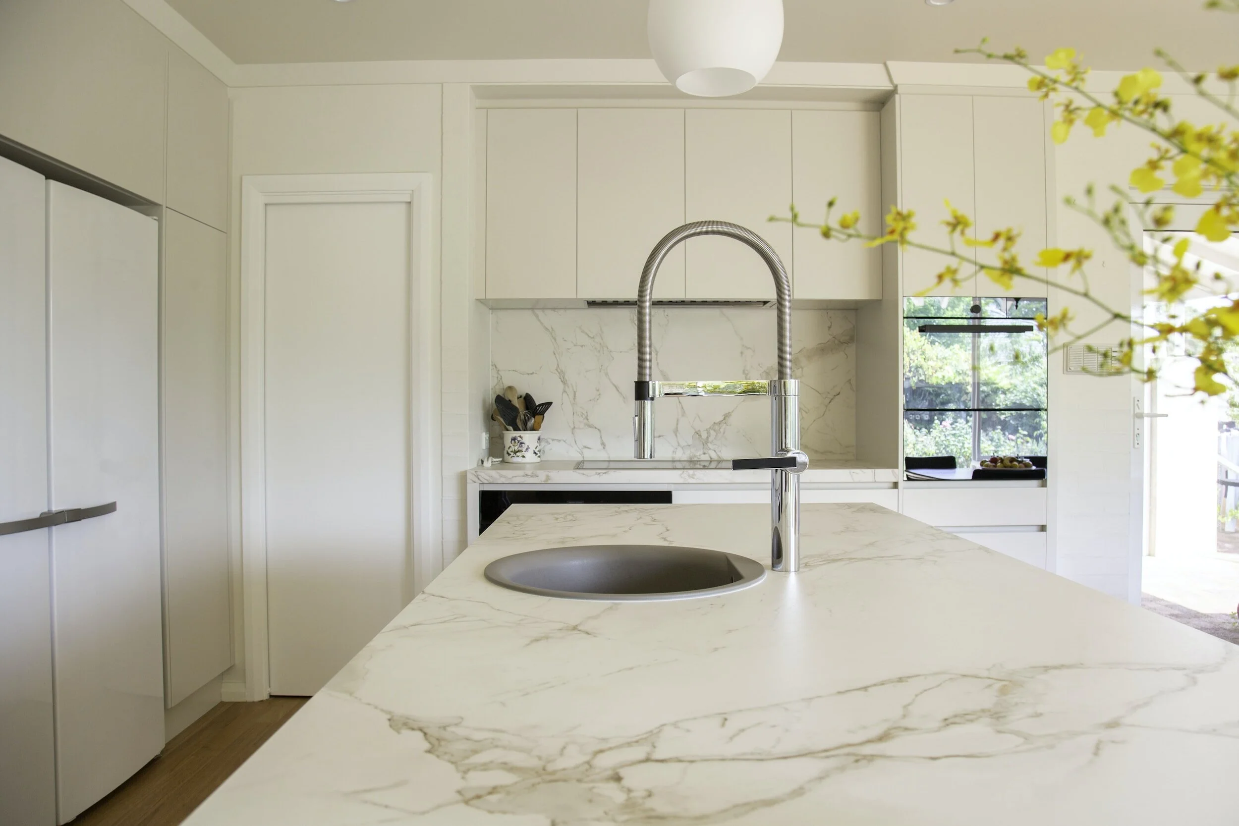 White Quartz Island with a sink and faucet