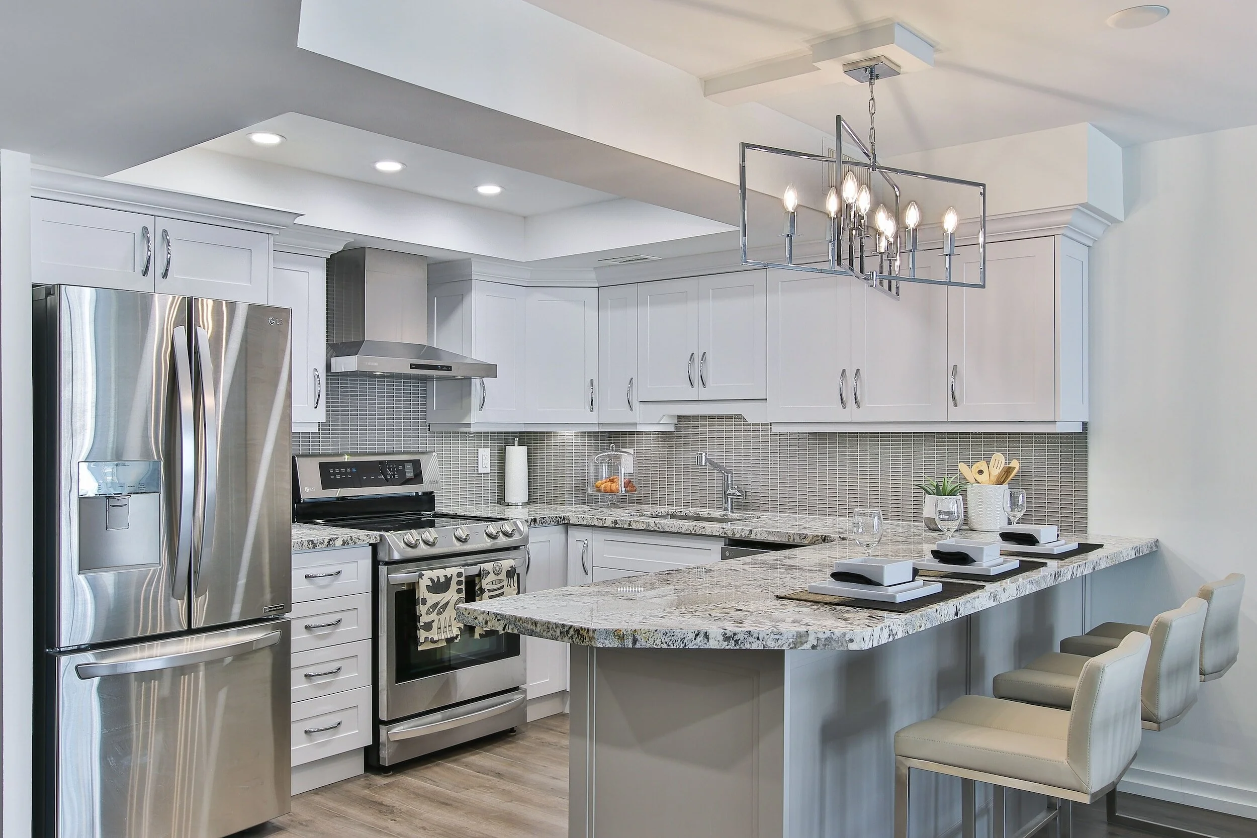 Granite countertops featured in a white kitchen with stainless steel appliances