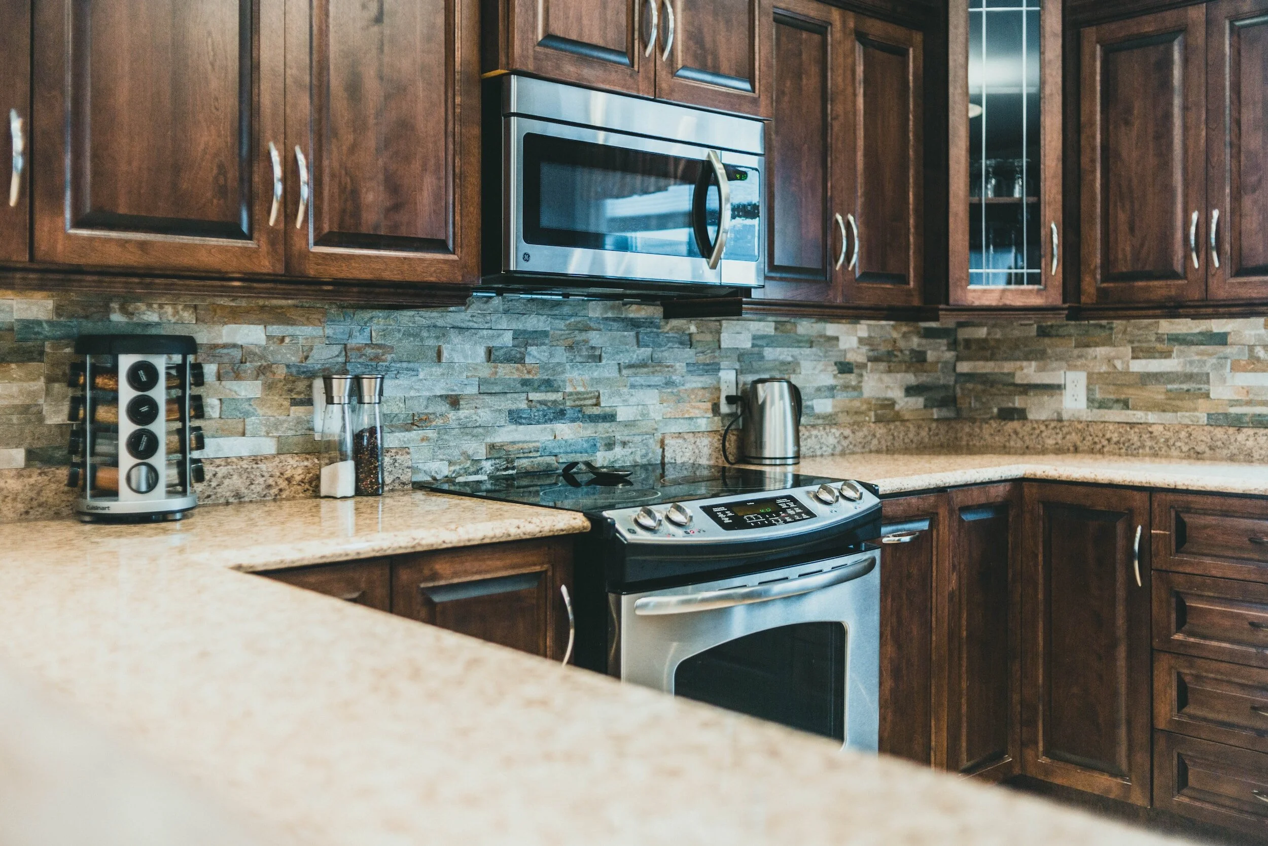 Tan granite countertops with brown cabinets