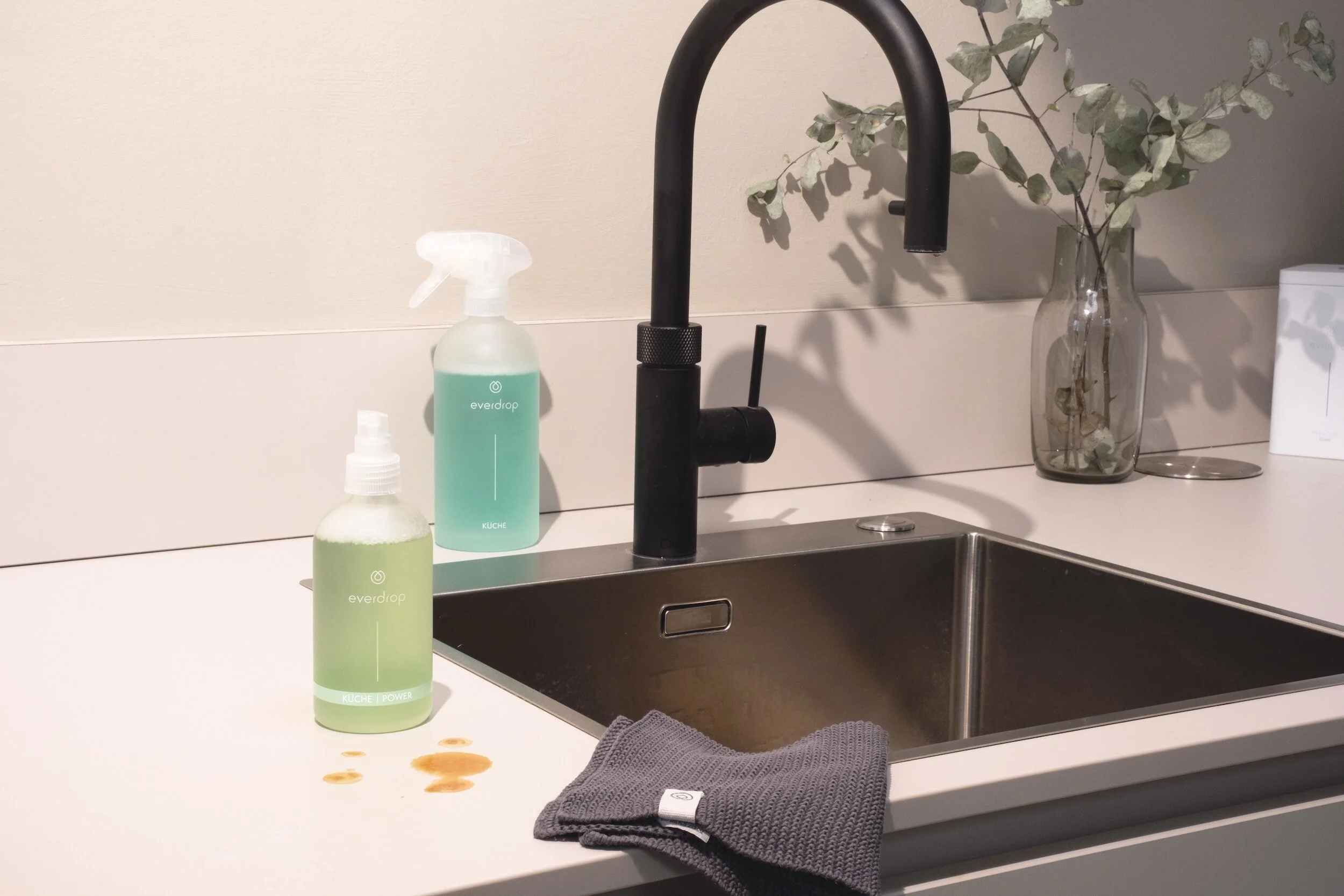 White Quartz countertops with a stain near a stainless steel sink